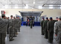 U.S. Air Force Airmen with the 23rd Fighter Group, salute the American flag during the posting of the colors and playing of the national anthem during the 23rd FG change of command ceremony at Moody Air Force Base, Ga., July 26, 2011. The ceremony is a time-honored tradition in the military which visibly assures continuity of command. (U.S. Air Force photo by Senior Airman Stephanie Mancha/Released)