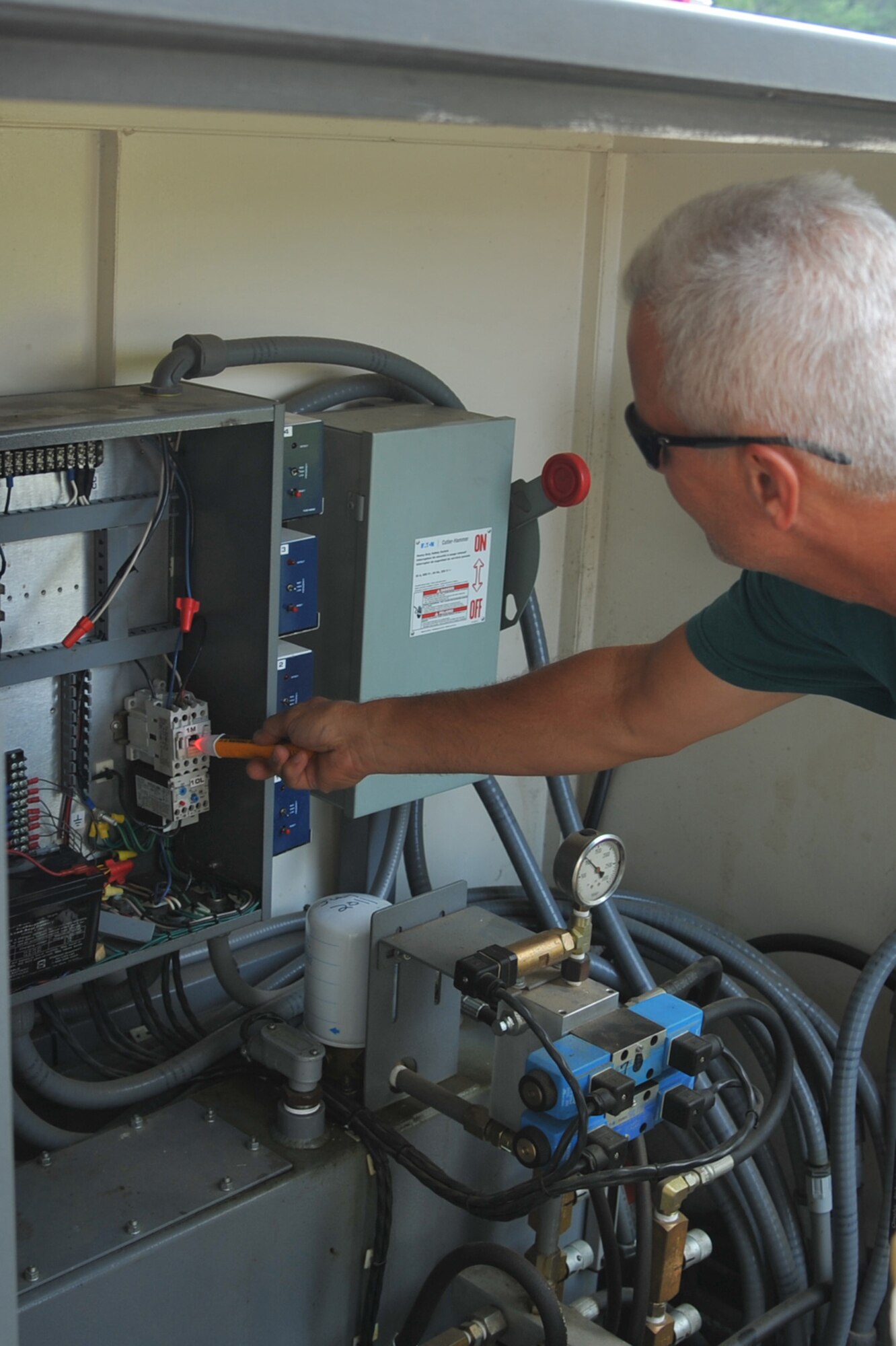 SEYMOUR JOHNSON AIR FORCE BASE, N.C.- John Koegel conducts a voltage test in an electric panel here, July 25, 2011. Using a voltage tester saves time and allows for quicker troubleshooting. Koegel is a 4th Civil Engineer Squadron work leader and a native of Severna Park, Md. (U.S. Air Force photo by Senior Airman Whitney Lambert/ Released)