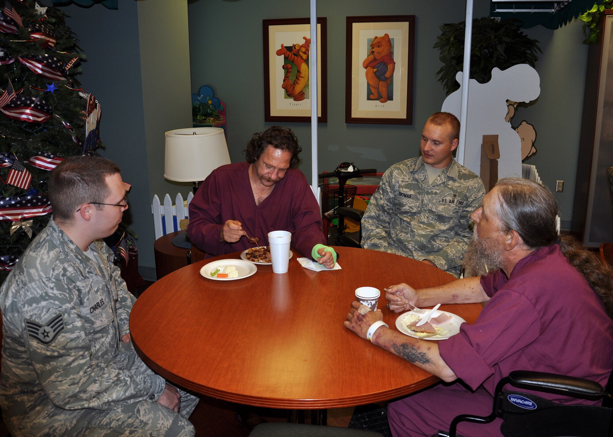 WRIGHT-PATTERSON AIR FORCE BASE, Ohio – Staff Sgt. Jonathan Charles and Senior Airman Ryan Thomas, both from the 445th Aeromedical Staging Squadron, along with 13 fellow ASTS reservists visit with Dayton Veterans Affairs Hospice and Palliative Care patients July 21 during the Quality of Life party at the facility. (U.S. Air Force photos/Senior Airman Matthew Cook)  
