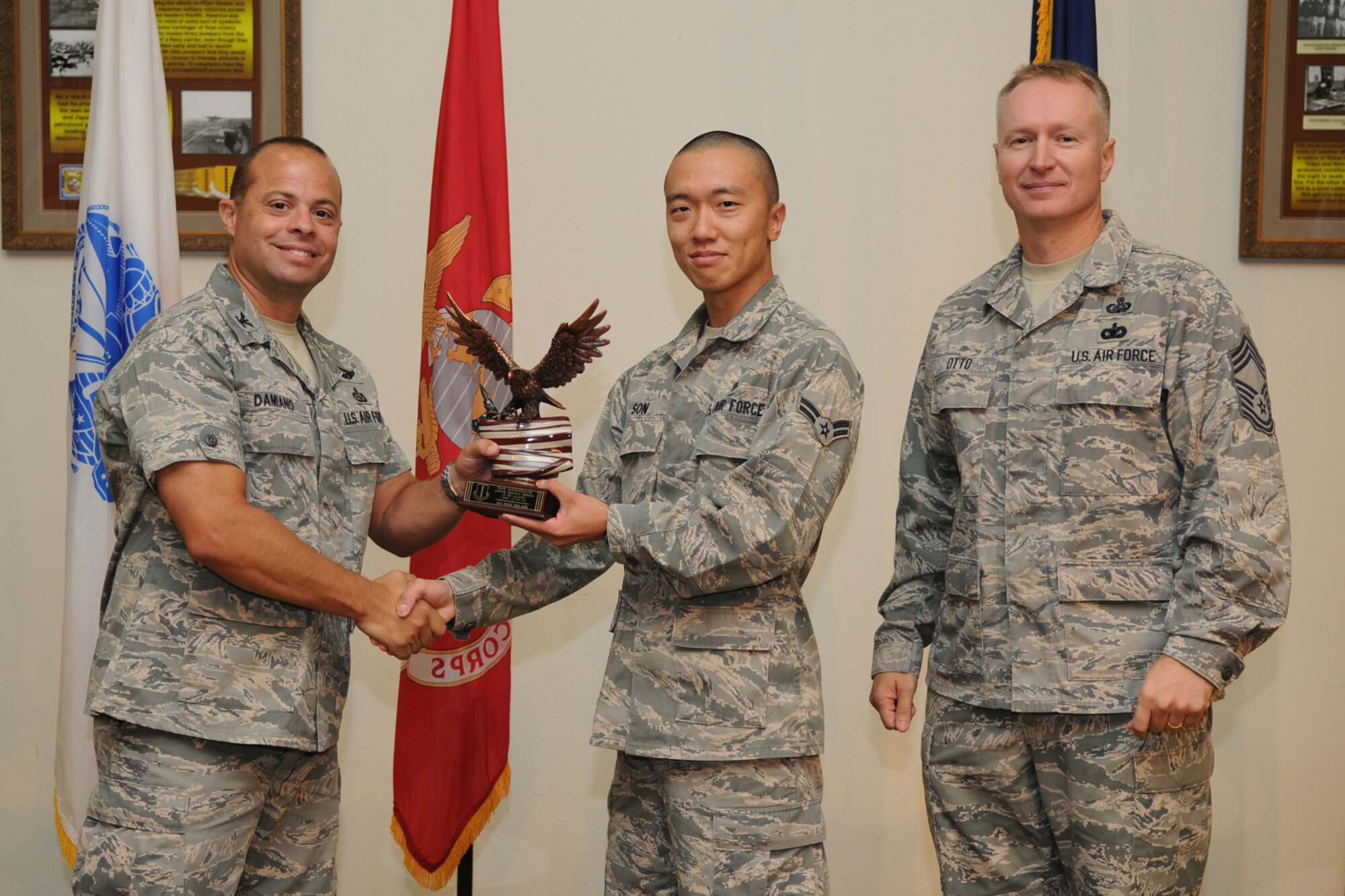 GOODFELLOW AIR FORCE BASE, Texas -- Col. Mark Damiano, 17th Training Wing Commander, and Chief Master Sgt. Quinton Otto, 17th Mission Support Group Superintendent, present the Team Gooodfellow Junior Enlisted of the Quarter award to Senior Airman Sung Min Sun, 17th Medical Group, during the quarterly awards breakfast July 26 at the Event Center here.  (U.S. Air Force photo/Senior Airman Heather L. Rodgers)