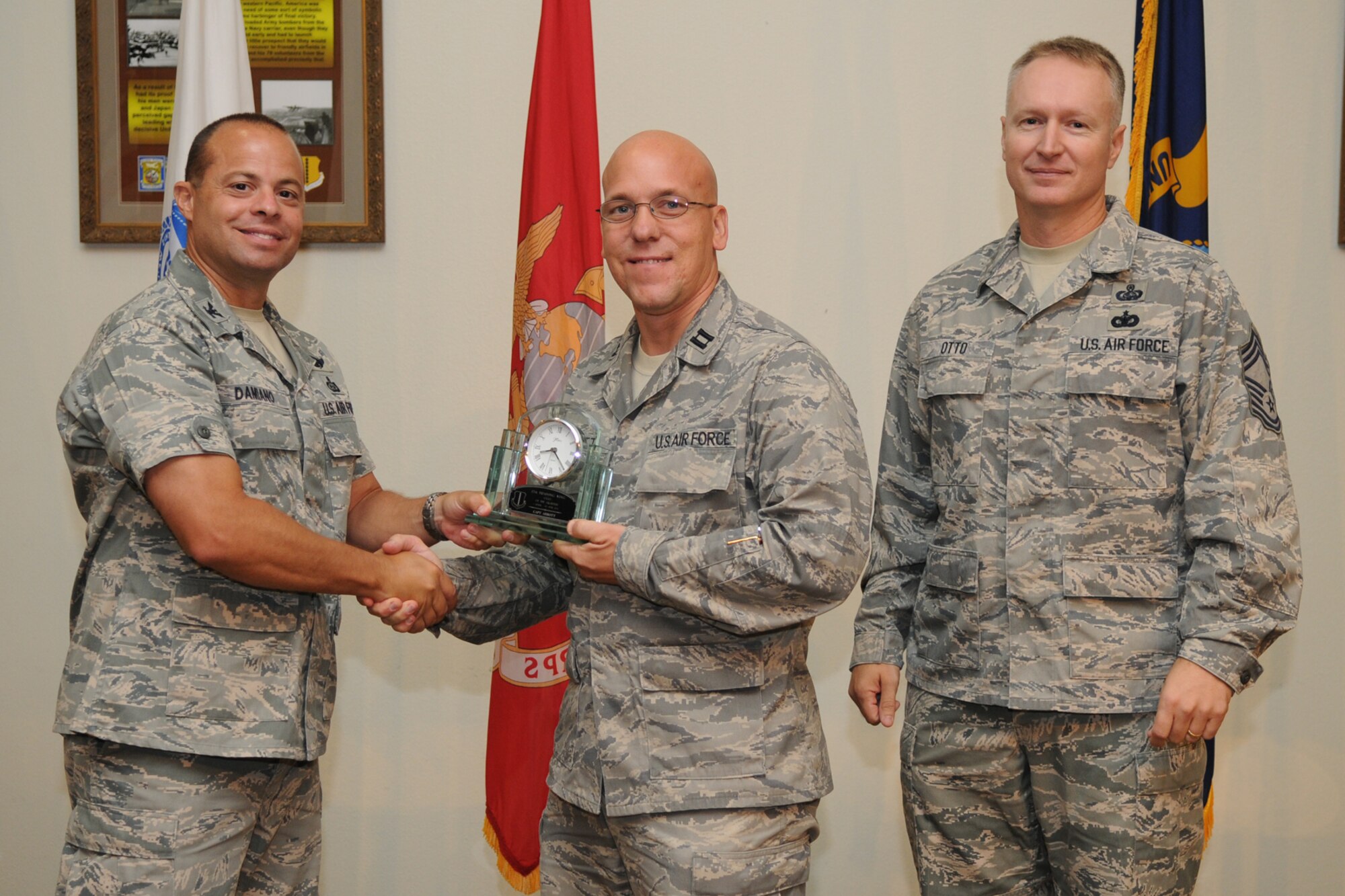 GOODFELLOW AIR FORCE BASE, Texas -- Col. Mark Damiano, 17th Training Wing Commander, and Chief Master Sgt. Quinton Otto, 17th Mission Support Group Superintendent, present the 17th Training Wing Company Grade Officer of the Quarter to Capt. David Abbott, 17th Medical Group, during the quarterly awards breakfast July 26 at the Event Center here.  (U.S. Air Force photo/Senior Airman Heather L. Rodgers)
