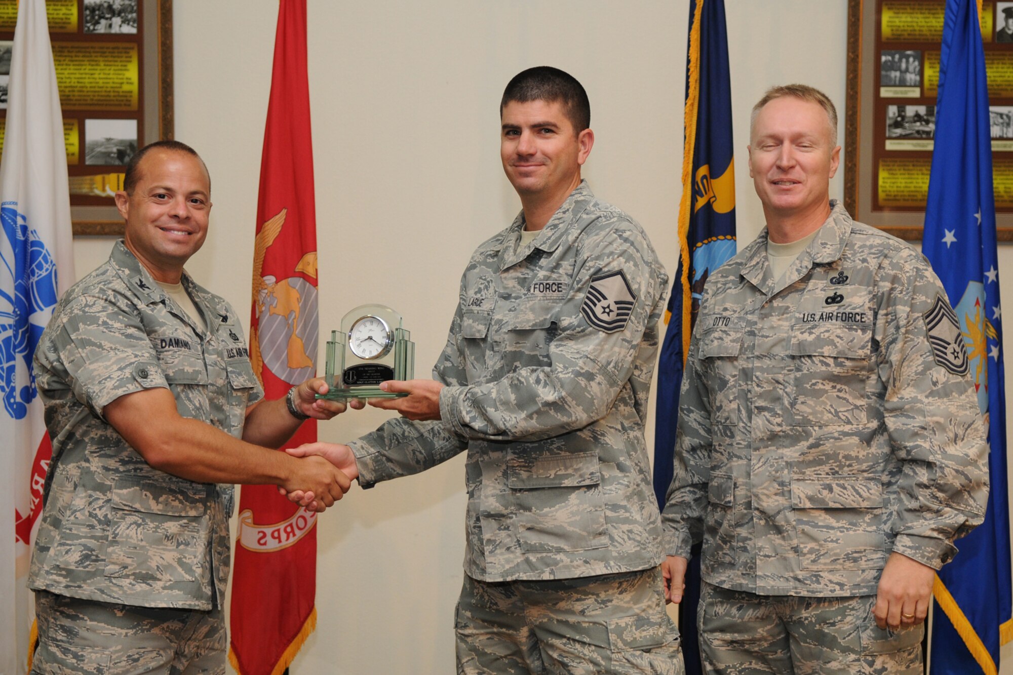 GOODFELLOW AIR FORCE BASE, Texas -- Col. Mark Damiano, 17th Training Wing Commander, and Chief Master Sgt. Quinton Otto, 17th Mission Support Group Superintendent, present the 17th Training Wing Senior NCO of the Quarter to Master Sgt. Clayton  LaRue, 17th Mission Support Group, during the quarterly awards breakfast July 26 at the Event Center here.  (U.S. Air Force photo/Senior Airman Heather L. Rodgers)
