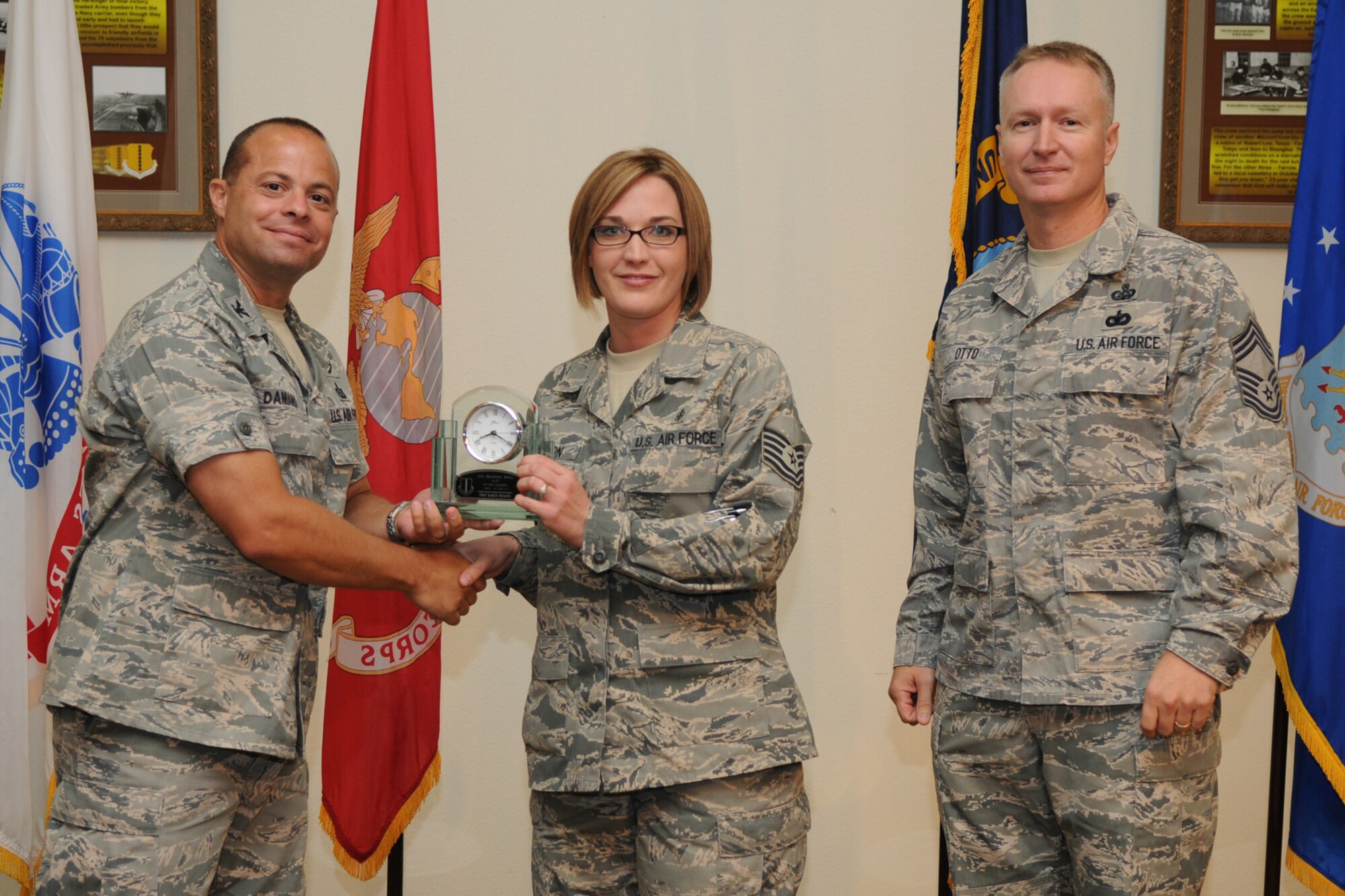 GOODFELLOW AIR FORCE BASE, Texas -- Col. Mark Damiano, 17th Training Wing Commander, and Chief Master Sgt. Quinton Otto, 17th Mission Support Group Superintendent, present the 17th Training Wing NCO of the Quarter to Tech. Sgt. Karen Nelson, 17th Medical Group, during the quarterly awards breakfast July 26 at the Event Center here.  (U.S. Air Force photo/Senior Airman Heather L. Rodgers)
