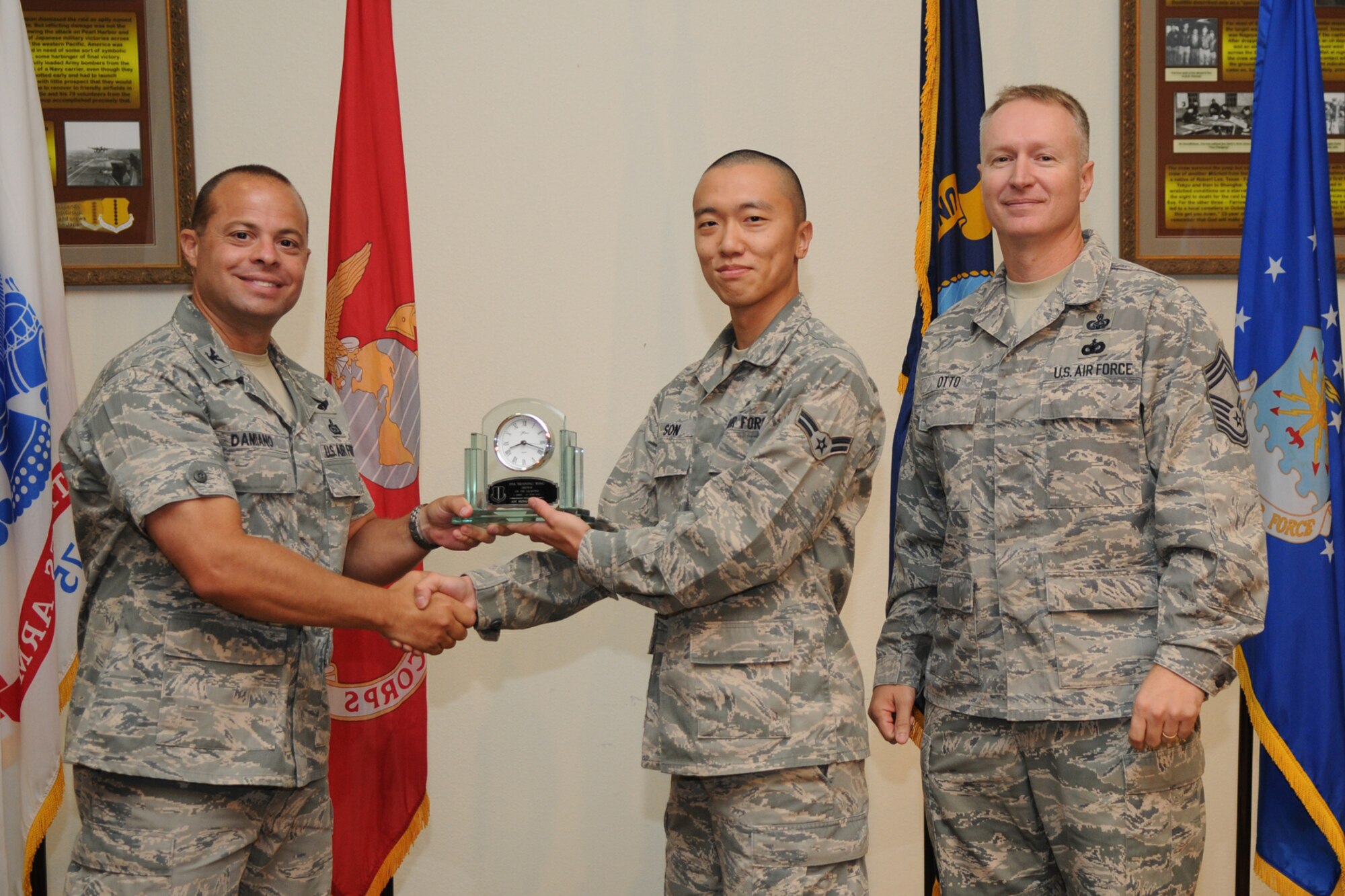 GOODFELLOW AIR FORCE BASE, Texas -- Col. Mark Damiano, 17th Training Wing Commander, and Chief Master Sgt. Quinton Otto, 17th Mission Support Group Superintendent, present the 17th Training Wing Airman of the Quarter to Senior Airman Sung Min Sun, 17th Medical Group, during the quarterly awards breakfast July 26 at the Event Center here.  (U.S. Air Force photo/Senior Airman Heather L. Rodgers)
