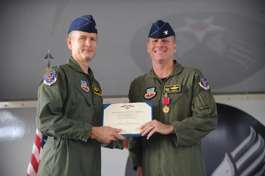 U.S. Air Force Col. Skip Hinman, Outgoing 23rd Fighter Group commander (right), receives the Legion of Merit award from Col. Billy Thompson, 23rd Wing commander, during a change of command ceremony at Moody Air Force Base, Ga., July 26, 2011. Hinman earned the award for his leadership of the group. (U.S Air Force photo by Airman 1st Class Paul Francis/Released)