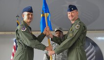 U.S. Air Force Col. Billy Thompson, 23rd Wing commander, passes the guidon to Lt. Col. Ronald Stuewe Jr., incoming 23rd Fighter Group commander, during a change of command ceremony at Moody Air Force Base, Ga., July 26, 2011. Prior to assuming command of the group, Stuewe served as the 81st Fighter Squadron commander at Spangdahlem Air Base, Germany. (U.S Air Force photo by Airman 1st Class Paul Francis/Released)