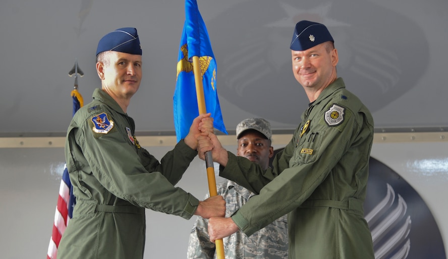 U.S. Air Force Col. Billy Thompson, 23rd Wing commander, passes the guidon to Lt. Col. Ronald Stuewe Jr., incoming 23rd Fighter Group commander, during a change of command ceremony at Moody Air Force Base, Ga., July 26, 2011. Prior to assuming command of the group, Stuewe served as the 81st Fighter Squadron commander at Spangdahlem Air Base, Germany. (U.S Air Force photo by Airman 1st Class Paul Francis/Released)