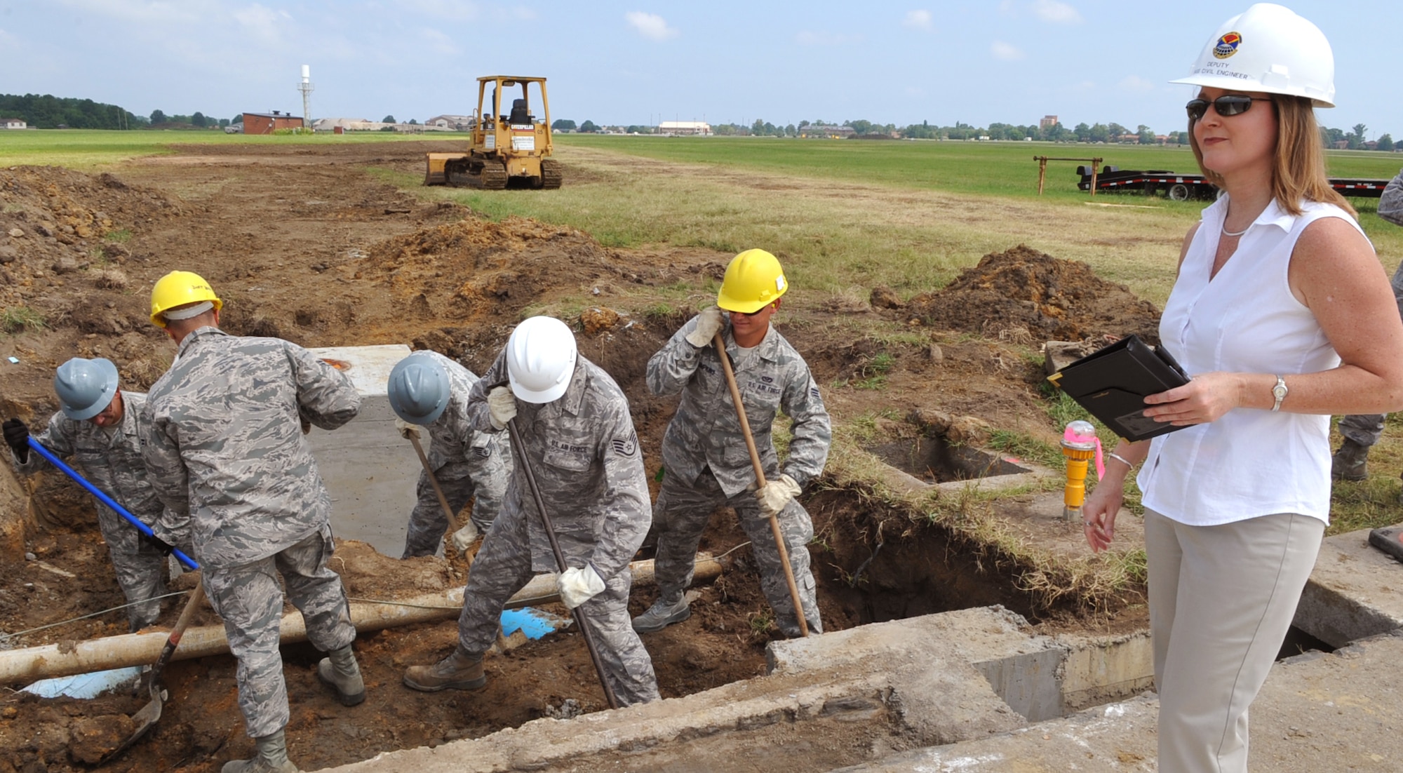 Brenda Cook, 633rd Civil Engineer Squadron deputy base civil engineer, observes Airmen performing maintenance on the flightline at Langley Air Force Base, Va., July 26, 2011. Ms. Cook earned the Air Force Association’s 2011 Outstanding Air Force Civilian Senior Manager of the Year Award for her accomplishments in the civil engineering field.  (U.S. Air Force photo by Staff Sgt. Logan Tuttle/Released)