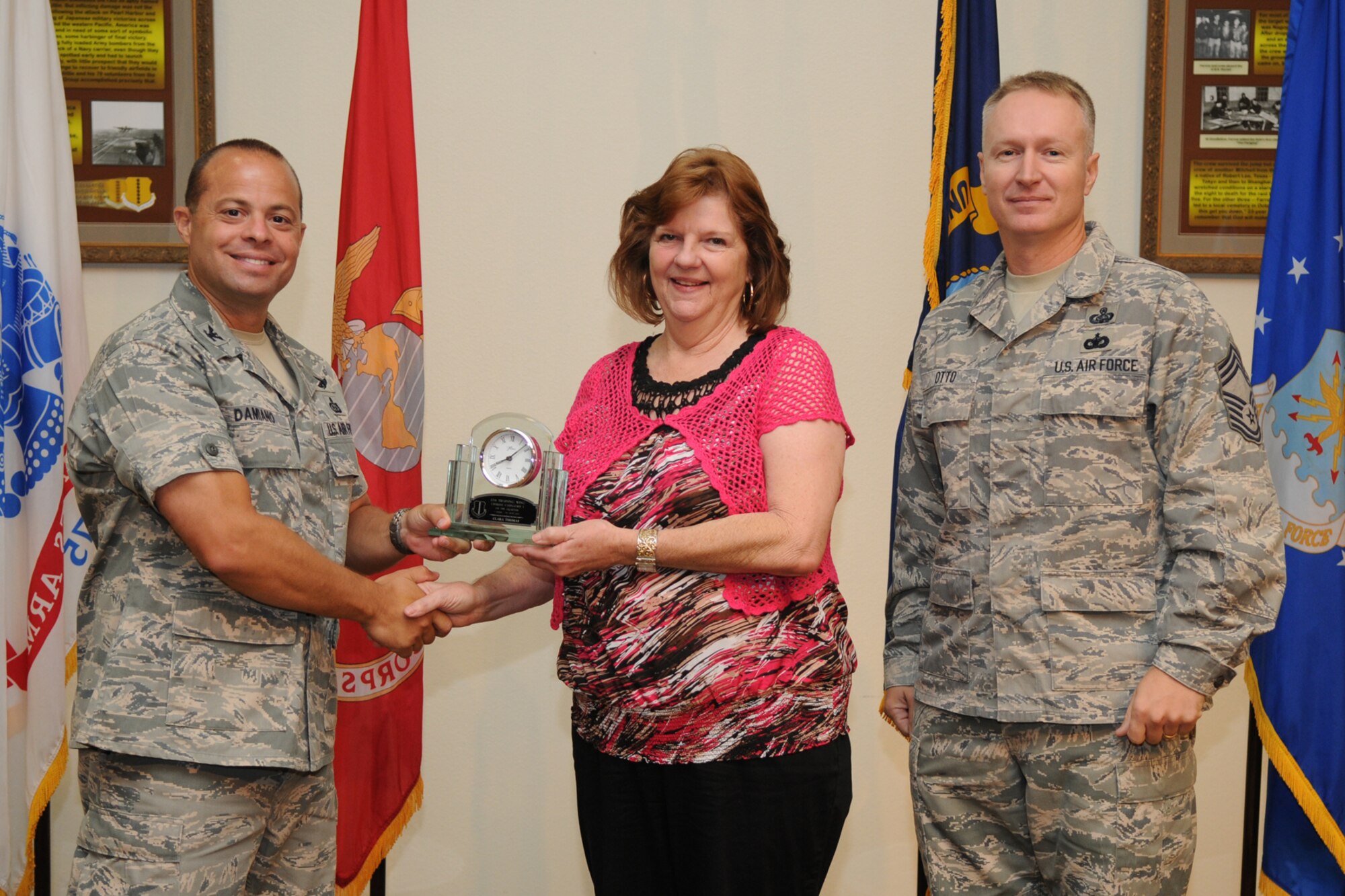 GOODFELLOW AIR FORCE BASE, Texas -- Col. Mark Damiano, 17th Training Wing Commander, and Chief Master Sgt. Quinton Otto, 17th Mission Support Group Superintendent, present the 17th Training Wing Civilian of the Quarter Category I to Clara Thomas, 17th Medical Group, during the quarterly awards breakfast July 26 at the Event Center here.  (U.S. Air Force photo/Senior Airman Heather L. Rodgers)
