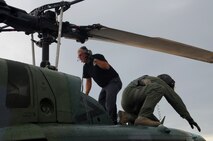 MINOT AIR FORCE BASE, N.D. -- Jeff Marcille, 54th Helicopter Squadron helicopter maintenance technician, ties down the rotors to the UH-1N "Huey" helicopter here, July 26. The mission of the 54th HS is to ensure the integrity of the 91st Missile Wing’s nuclear deterrence by providing immediate, flexible and effective combat helicopter support anywhere, anytime. (U.S. Air Force photo/ Senior Airman Jesse Lopez)
