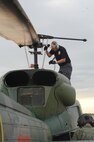 MINOT AIR FORCE BASE, N.D. -- Jeff Marcille, 54th Helicopter Squadron helicopter maintenance technician, ties down the rotors to the UH-1N "Huey" helicopter here, July 26. The mission of the 54th HS is to ensure the integrity of the 91st Missile Wing’s nuclear deterrence by providing immediate, flexible and effective combat helicopter support anywhere, anytime. (U.S. Air Force photo/ Senior Airman Jesse Lopez)
