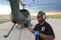 MINOT AIR FORCE BASE, N.D. -- Frantz Jean-Pierre, 54th Helicopter Squadron helicopter maintenance technician, ties down the rotors to the UH-1N "Huey" helicopter here, July 26. The mission of the 54th HS is to ensure the integrity of the 91st Missile Wing’s nuclear deterrence by providing immediate, flexible and effective combat helicopter support anywhere, anytime. (U.S. Air Force photo/ Senior Airman Jesse Lopez)