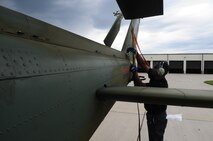 MINOT AIR FORCE BASE, N.D. -- Frantz Jean-Pierre, 54th Helicopter Squadron helicopter maintenance technician, ties down the rotors to the UH-1N "Huey" helicopter here, July 26. The mission of the 54th HS is to ensure the integrity of the 91st Missile Wing’s nuclear deterrence by providing immediate, flexible and effective combat helicopter support anywhere, anytime. (U.S. Air Force photo/ Senior Airman Jesse Lopez)