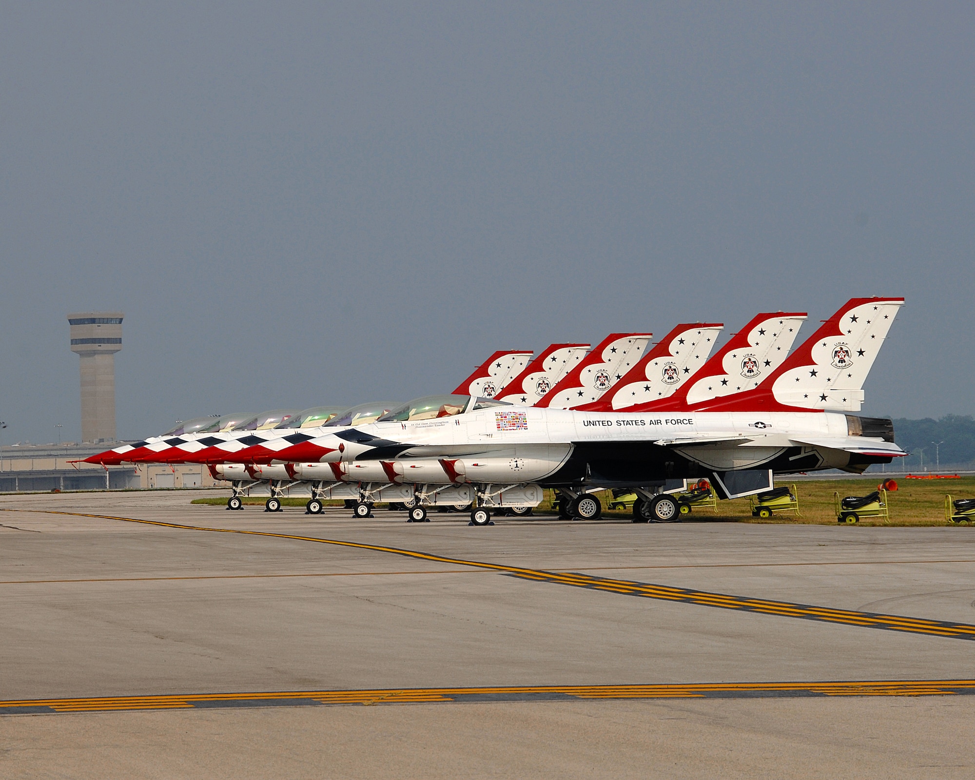 The Air Force Thunderbirds are lined up and ready to go, July 23, during the 2011 Dayton Airshow at Dayton International Airport, Ohio.  The Thunderbirds are the air demonstration squadron of the U.S. Air Force, and based at Nellis AFB in Las Vegas, Nevada. The squadron tours the world, performing thrilling aerobatic flight formations in specially marked F-16 jet aircraft. (USAF photo by Ben Strasser)
