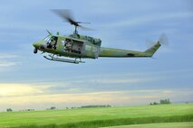 MINOT AIR FORCE BASE, N.D. -- Members of the 54th Helicopter Squadron land a UH-1N “Huey” helicopter onto the tarmac as part of a routine flying mission, here July 26. The mission of the 54th HS is to ensure the integrity of the 91st Missile Wing’s nuclear deterrence by providing immediate, flexible and effective combat helicopter support anywhere, anytime. (U.S. Air Force photo/ Senior Airman Jesse Lopez)