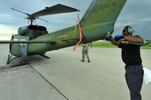 MINOT AIR FORCE BASE, N.D. -- Frantz Jean-Pierre, 54th Helicopter Squadron maintainer, secures the rotors of a UH-1N “Huey” helicopter after a routine flying mission, here July 26. The mission of the 54th HS is to ensure the integrity of the 91st Missile Wing’s nuclear deterrence by providing immediate, flexible and effective combat helicopter support anywhere, anytime. (U.S. Air Force photo/ Senior Airman Jesse Lopez)