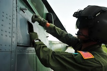 MINOT AIR FORCE BASE, N.D. -- 1st Lt. Steven Bennett, 54th Helicopter Squadron pilot, performs post-flight maintenance on a UH-1N “Huey” helicopter on the tarmac as part of a routine flying mission, here July 26. The mission of the 54th HS is to ensure the integrity of the 91st Missile Wing’s nuclear deterrence by providing immediate, flexible and effective combat helicopter support anywhere, anytime. (U.S. Air Force photo/ Senior Airman Jesse Lopez)