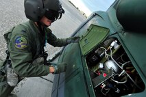 MINOT AIR FORCE BASE, N.D. -- 1st Lt. Steven Bennett, 54th Helicopter Squadron pilot, performs post-flight maintenance on a UH-1N “Huey” helicopter on the tarmac as part of a routine flying mission, here July 26. The mission of the 54th HS is to ensure the integrity of the 91st Missile Wing’s nuclear deterrence by providing immediate, flexible and effective combat helicopter support anywhere, anytime. (U.S. Air Force photo/ Senior Airman Jesse Lopez)