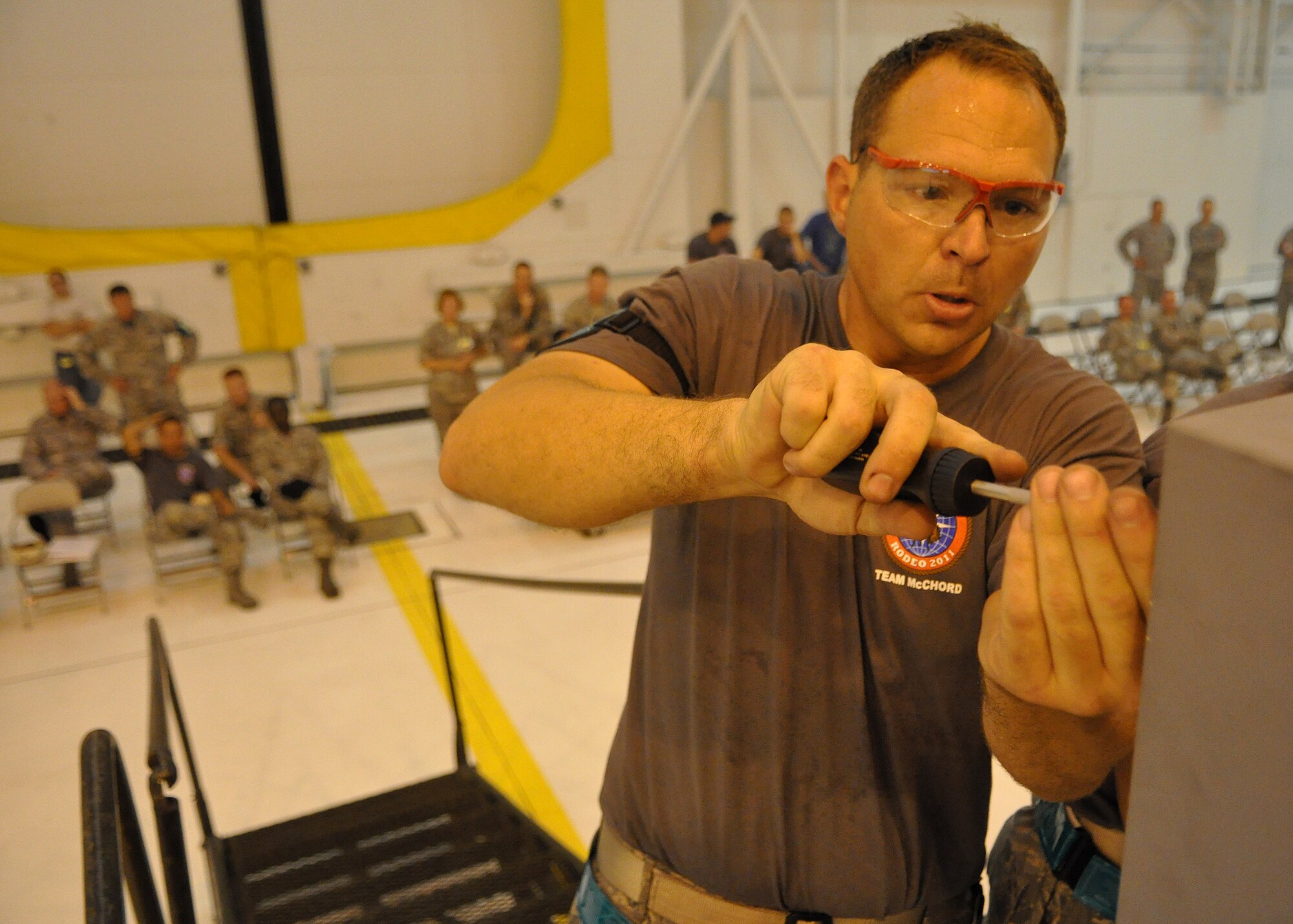 Tech. Sgt. Justin Dancer, 62nd Maintenance Rodeo team member, adjusts the final screw on a simulated C-17 Globemaster III during the Maintenance Skills Competition as part of Air Mobility Rodeo July 25, 2011, at Joint Base Lewis-McChord, Wash. Rodeo is a bi-annual competition that encompasses all aspects of Air Mobility Command, including aerial port, aeromedical evacuation, maintenance, security forces, and financial management. (U.S. Air Force photo/Airman 1st Class Leah Young)