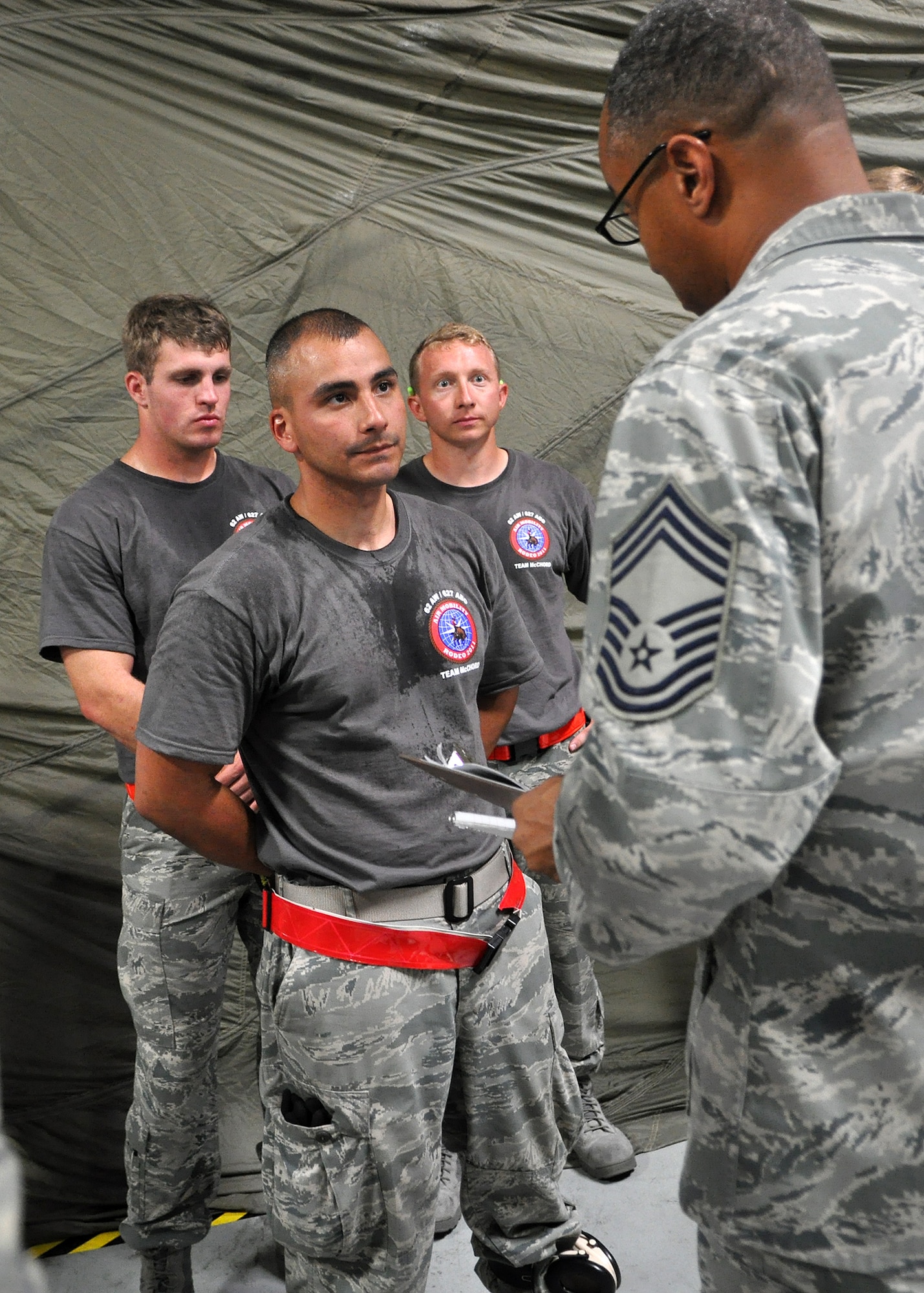The 62nd Aerial Port Rodeo receives feedback from an Air Mobility Command Rodeo umpire after a pallet buildup competition as part of Air Mobility Rodeo July 25, 2011, at Joint Base Lewis-McChord, Wash. Rodeo is a bi-annual competition that encompasses all aspects of Air Mobility Command, including aerial port, aeromedical evacuation, maintenance, security forces, and financial management. The team also competed in a 10k forklift driving course and a timed engine running on- and off-load event.  (U.S. Air Force photo/Airman 1st Class Leah Young)