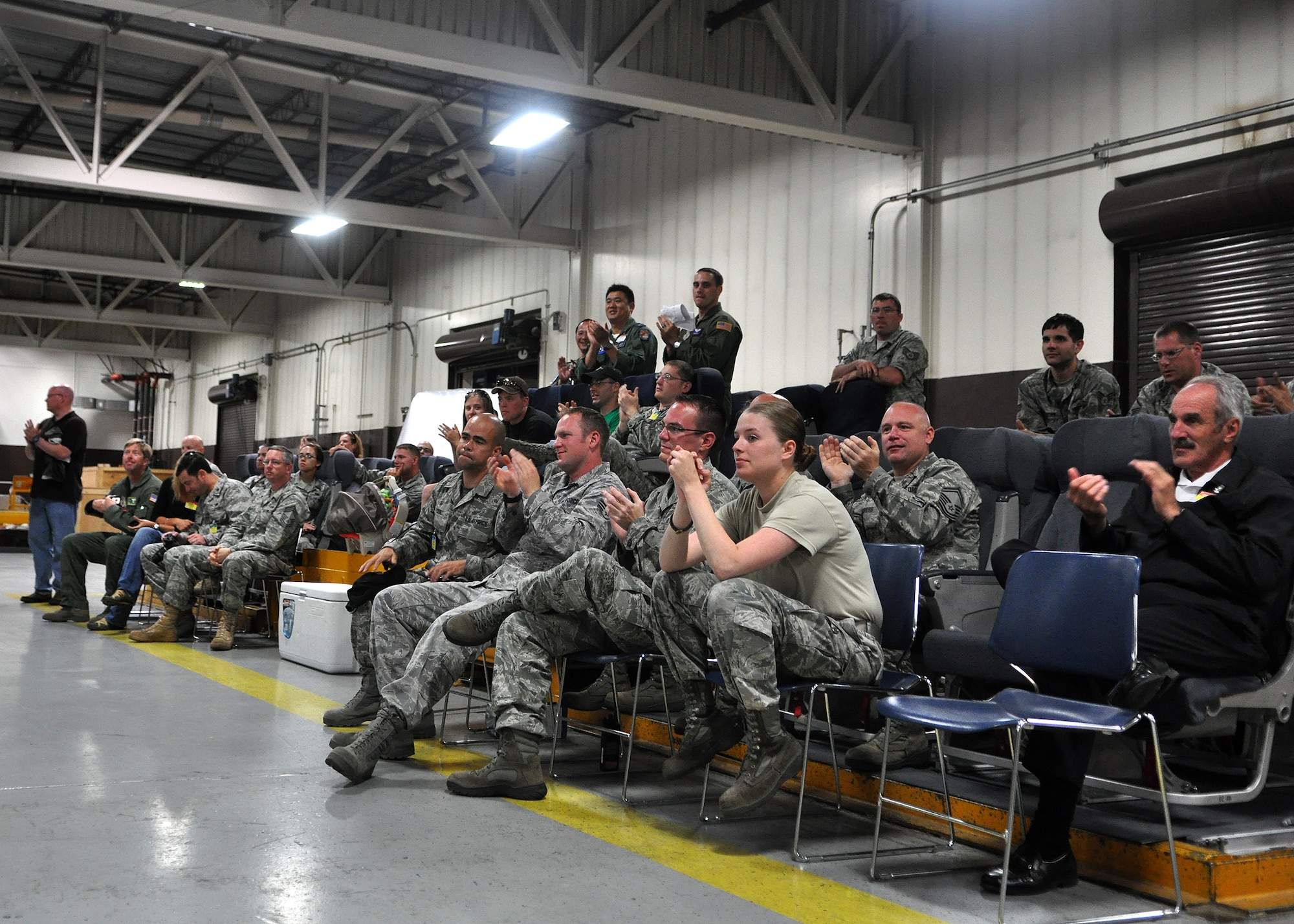 Co-workers and 62nd Airlift Wing leadership support the Aerial Port Rodeo team as they compete in a pallet buildup competition as part of Air Mobility Rodeo July 25, 2011, at Joint Base Lewis-McChord, Wash. Rodeo is a bi-annual competition that encompasses all aspects of Air Mobility Command, including aerial port, aeromedical evacuation, maintenance, security forces, and financial management. The team also competed in a 10k forklift driving course and a timed engine running on- and off-load event. (U.S. Air Force photo/Airman 1st Class Leah Young)