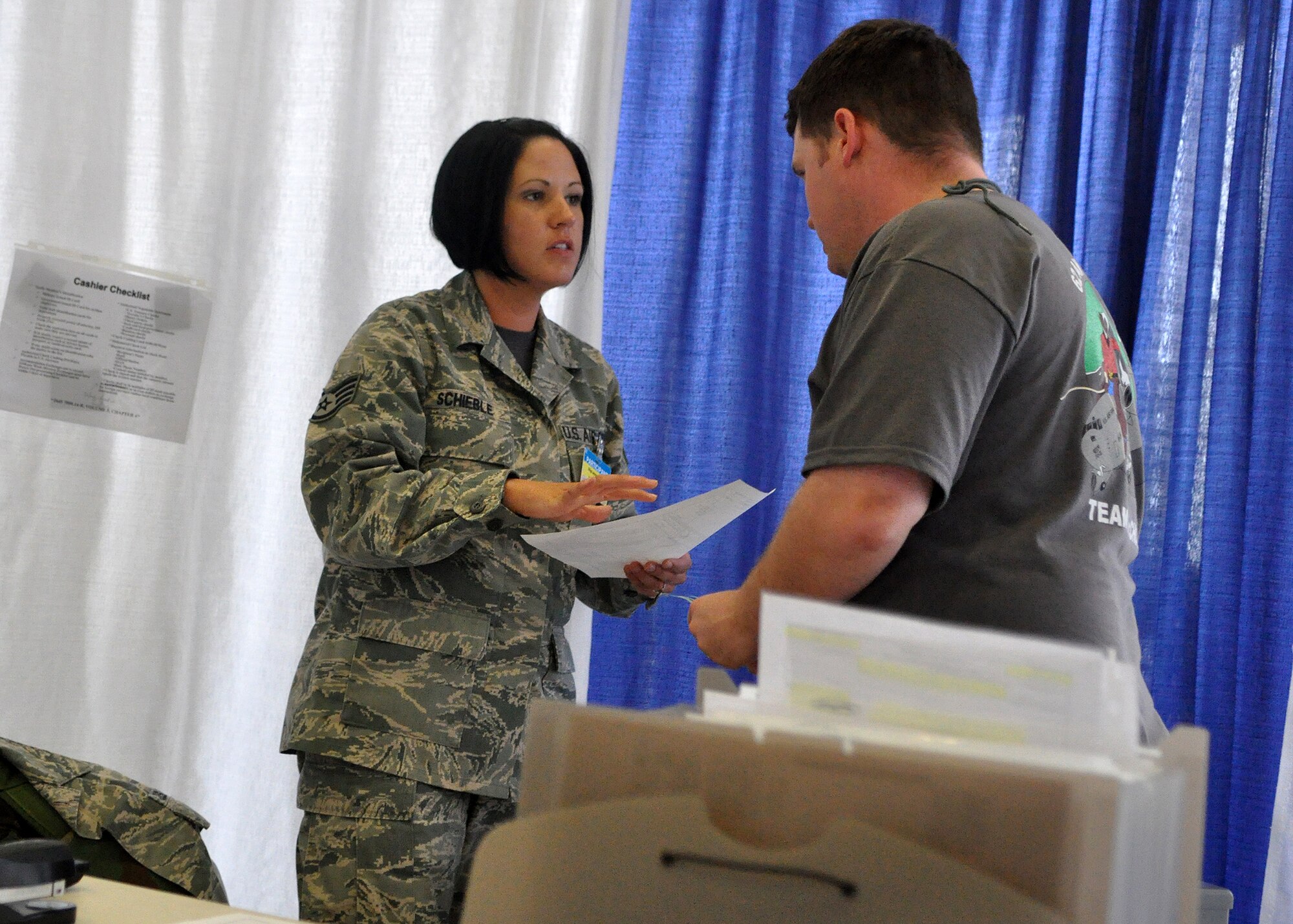 Staff Sgt. Jaysa Schieble, left, 62nd Financial Management team chief, speaks with Senior Airman Cody Frasch, 62nd Financial Management team member, while working through a financial scenario as part of the Rodeo competition July 25, 2011, at Joint Base Lewis-McChord, Wash. Rodeo is a bi-annual competition that encompasses all aspects of Air Mobility Command, including aerial port, aeromedical evacuation, maintenance, security forces, and for the first time, financial management. The team will compete in performance-based scenarios, small arms and a fitness course throughout the week. (U.S. Air Force photo/Airman 1st Class Leah Young)
