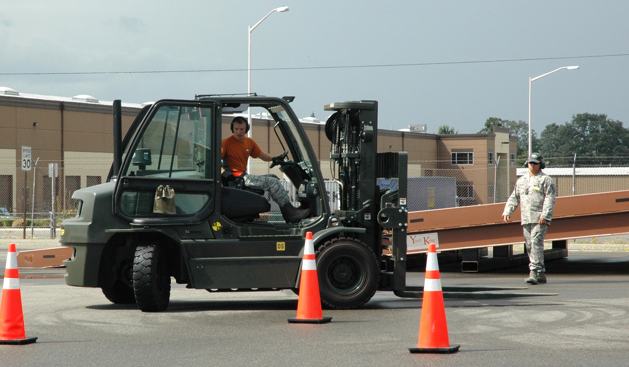 Tech. Sgt. Joshua Warbiany carefully maneuvers a 10K forklift through a path of cones during the Air Mobility Command's Rodeo 10K forklift event for the 446th Airlift Wing's Rodeo aerial port team.  With teammate Senior Airman Janelle Marshall, the Reservists' challenge was to demonstrate proficiency in maneuvering a 10K forklift through a driving course, while balancing objects on the lift. The Air Mobility Command's Rodeo is July 24-29 at McChord Field, Wash. (U.S. Air Force photo by Sandra Pishner)