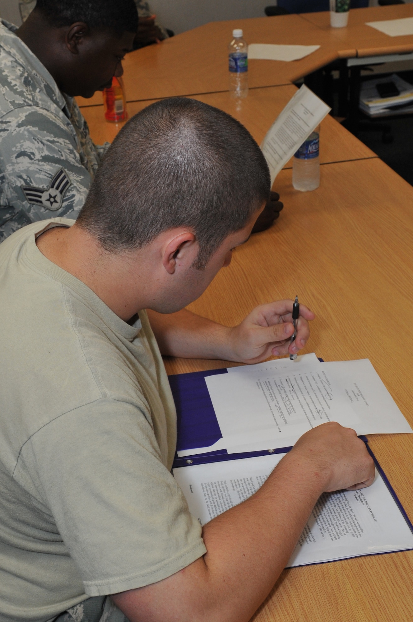 Senior Airman Shamus Brady, 605th Aircraft Maintenance Squadron, reviews his enlisted performance report. Airmen are given several tasks such as reviewing EPR’s so when they become non-commissioned officers they can rate their Airmen properly. (U.S. Air Force photo by Wayne Russell/Released)

