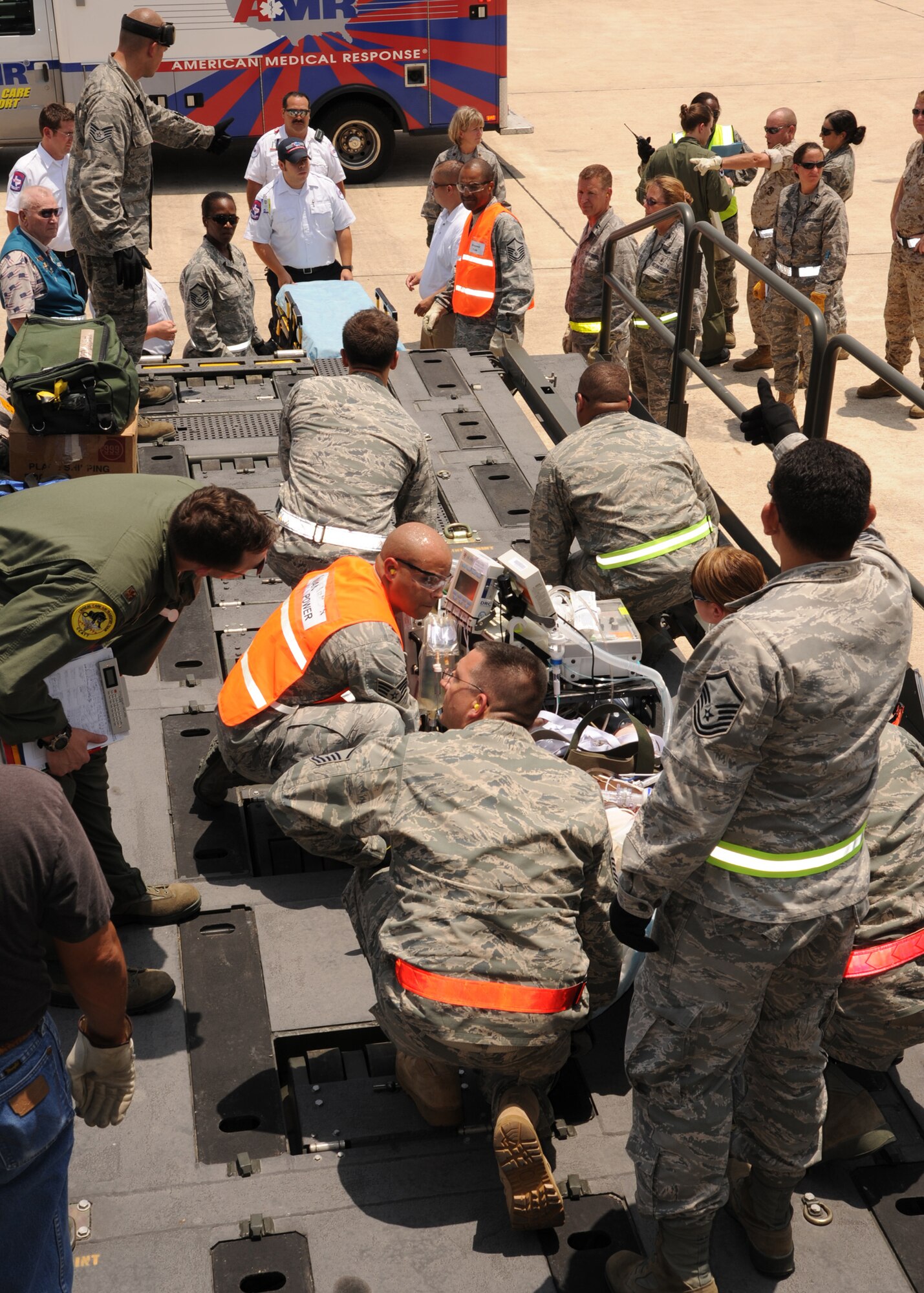 Contingency Aeromedical Staging Facility team members and other Air Force personnel prepare to move wounded warriors from a KC-135 Stratotanker July 19, 2011, at Lackland Air Force Base, Texas. CASF Airmen support patients in the military air evacuation system, providing medical care and comfort measures while those patients await transportation to their final destination. It was the first mission for the new facility that officially opened June 13. (U.S. Air Force photo/Senior Airman Kevin Iinuma)