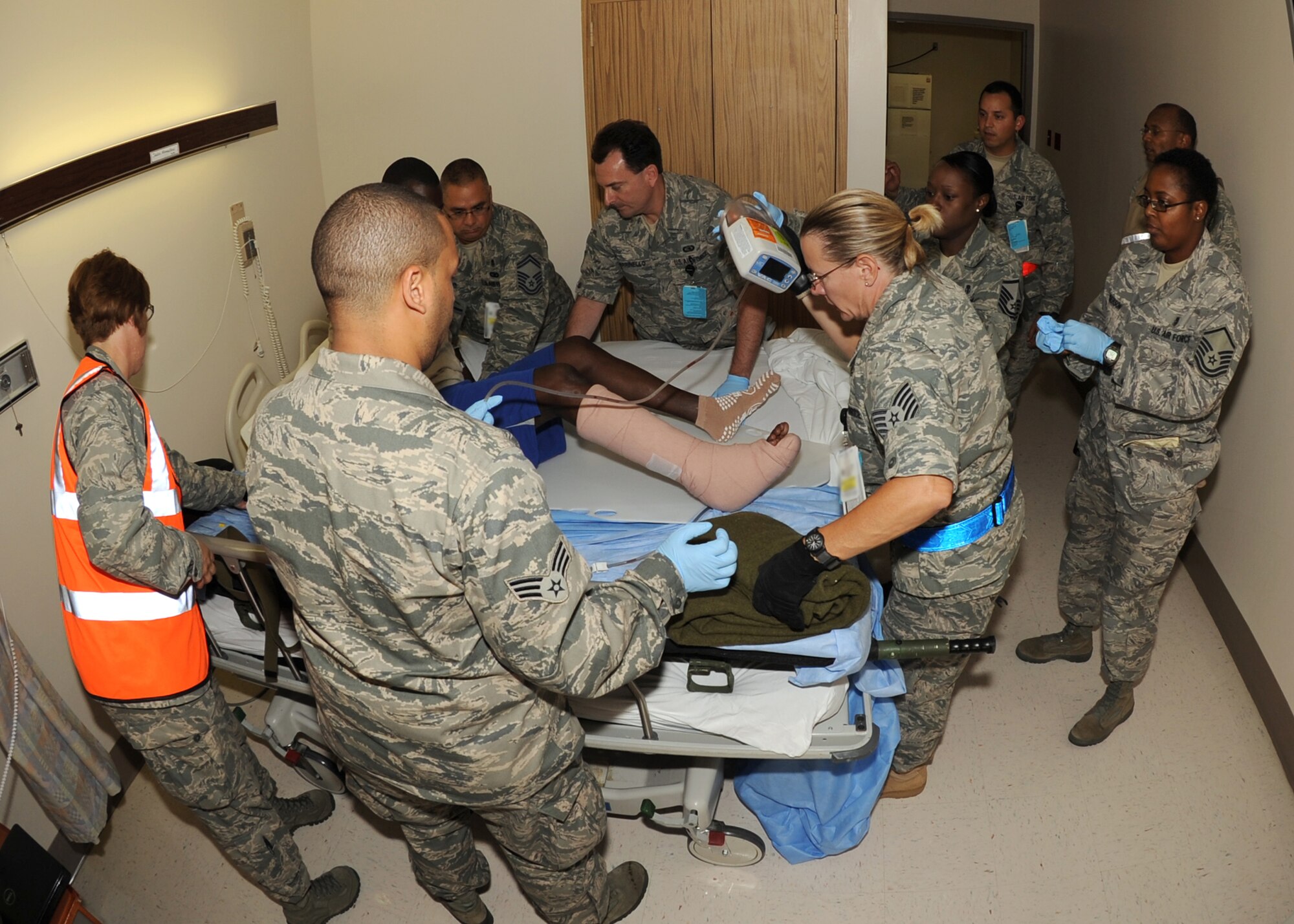 Contingency Aeromedical Staging Facility team members transfer a wounded warrior who had just arrived from Landstuhl Regional Medical Center in Germany July 19, 2011, to a bed at Wilford Hall Medical Center on Lackland Air Force Base, Texas. CASF Airmen support patients in the military air evacuation system, providing medical care and comfort measures while those patients await transportation to their final destination. It was the first mission for the new facility that officially opened June 13. (U.S. Air Force photo/Senior Airman Kevin Iinuma)