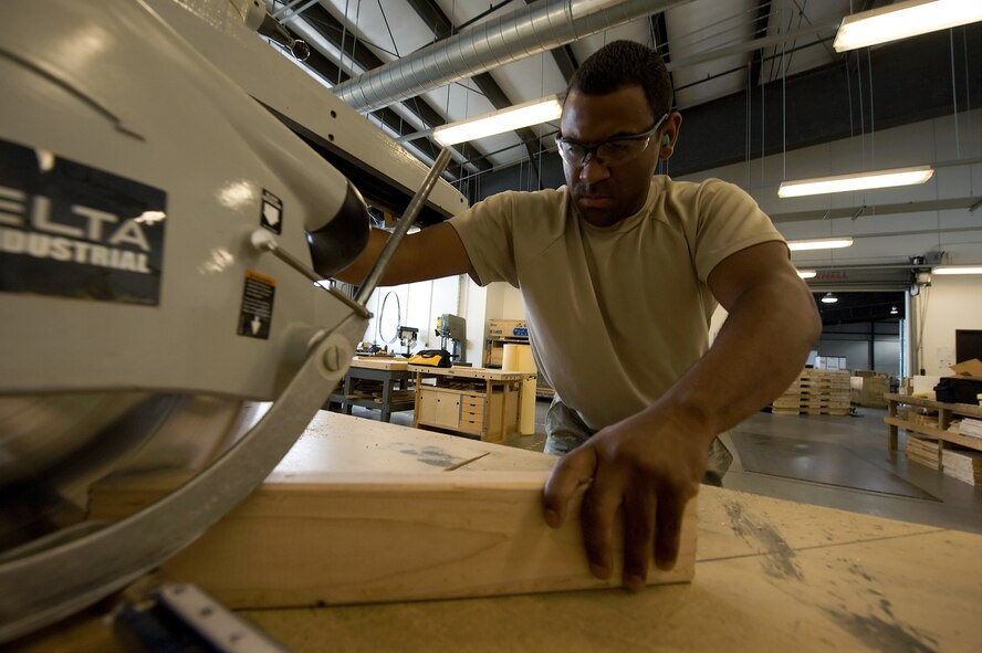 Senior Airman Samuel Vidot, a packing and crating specialist with the 436th Aerial Port Squadron, cuts 2x4’s to build a crate July 20, 2011, at Dover Air Force Base, Del. The packing and crating shop builds pallets and crates to fit any object that flies on military aircraft. (U.S. Air Force photo by Steve Kotecki)