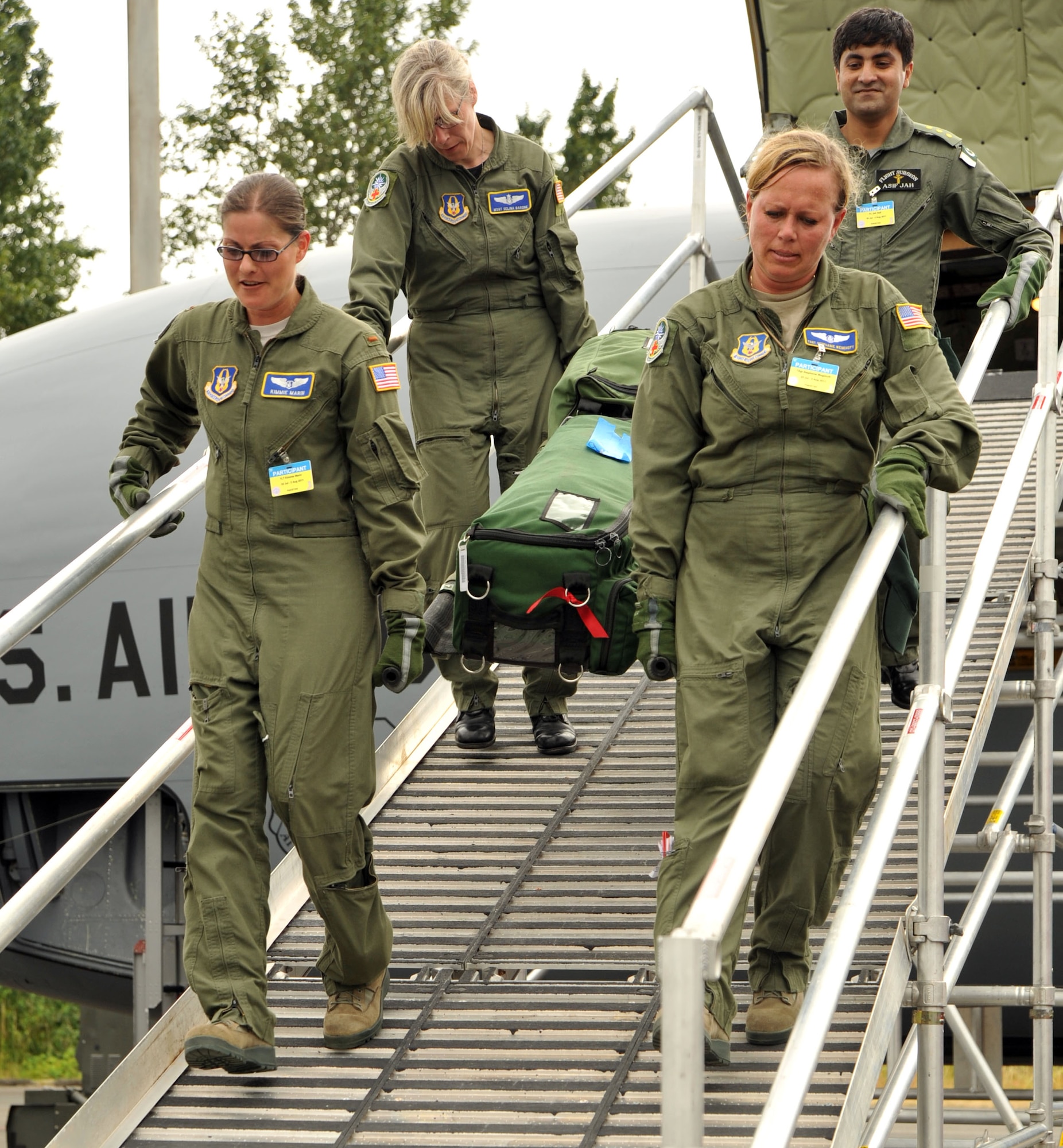 Members of the Pakistan Air Force team carry a gurney down the ramp after completing a Air Mobility Rodeo 2011 aeromedical evacuation competition.  When Rodeo officials realized that Pakistan had only sent one flight surgeon to compete in a five-person competition, they asked members of the 446th Aeromedical Evacuation Squadron to join Team Pakistan.