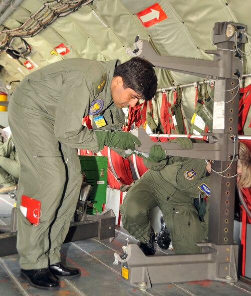 Capt. Asif Jah, a flight surgeon from the Pakistan Air Force, assembles a patient support pallet during and aeromedical evacuation competition July 25, 2011.  The support pallent is used downrange to hold gurneys on aircraft.  (U.S. Air Force photo/Senior Airman Abigail Klein)