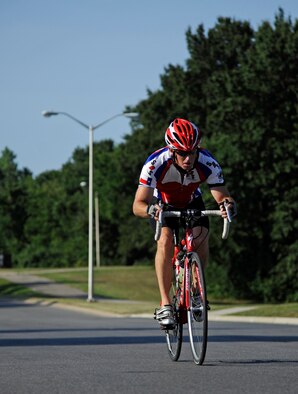 WHITEMAN AIR FORCE BASE, Mo. -- Todd Stewart, 509th Operation Support Squadron, finishes his 6-mile cycling course here July 22, 2011 during the 509th Force Support Squadron's 2011 Triathlon. Mr. Stewart finished in first place in the men-over-40 category with a time of one hour and eight minutes. (U.S. Air Force photo by Airman 1st Class Cody H. Ramirez)