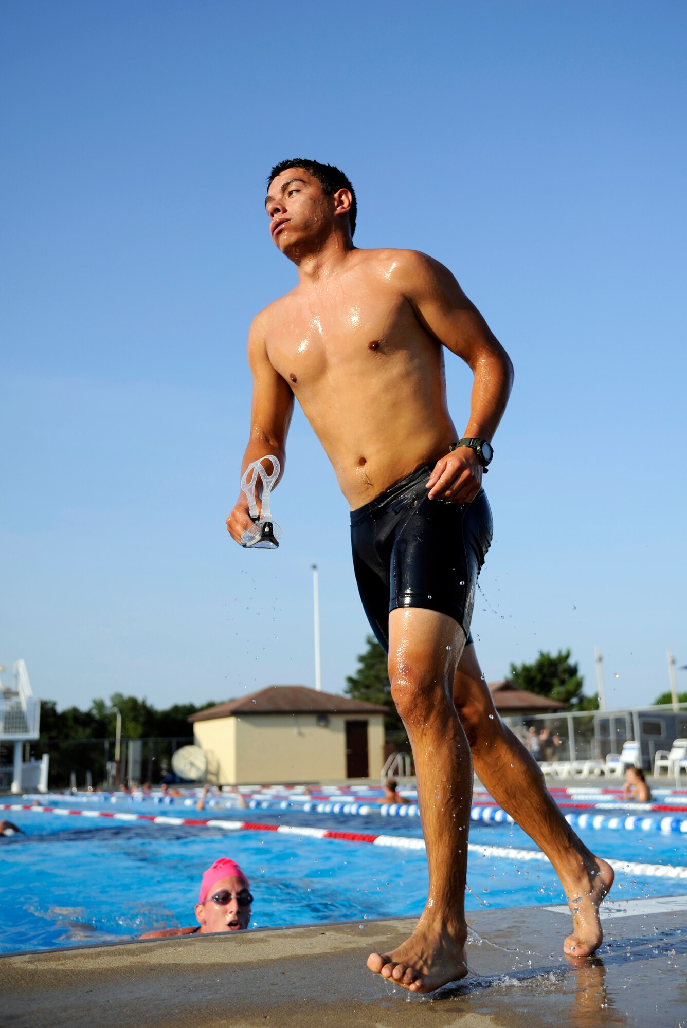 WHITEMAN AIR FORCE BASE, Mo. -- Senior Airman Estiven Gonzalez, 509th Operations Support Squadron, rushes out of the pool here July 22, 2011 after swimming 435 meters in the first section of the 509th Force Support Squadron's 2011 Triathlon. Airman Gonzalez finished second for the male-under-40 category and finished first for the co-ed category alongside his teammate, Capt. Amanda Patton, 509th FSS.(U.S. Air Force photo by Airman 1st Class Cody H. Ramirez)