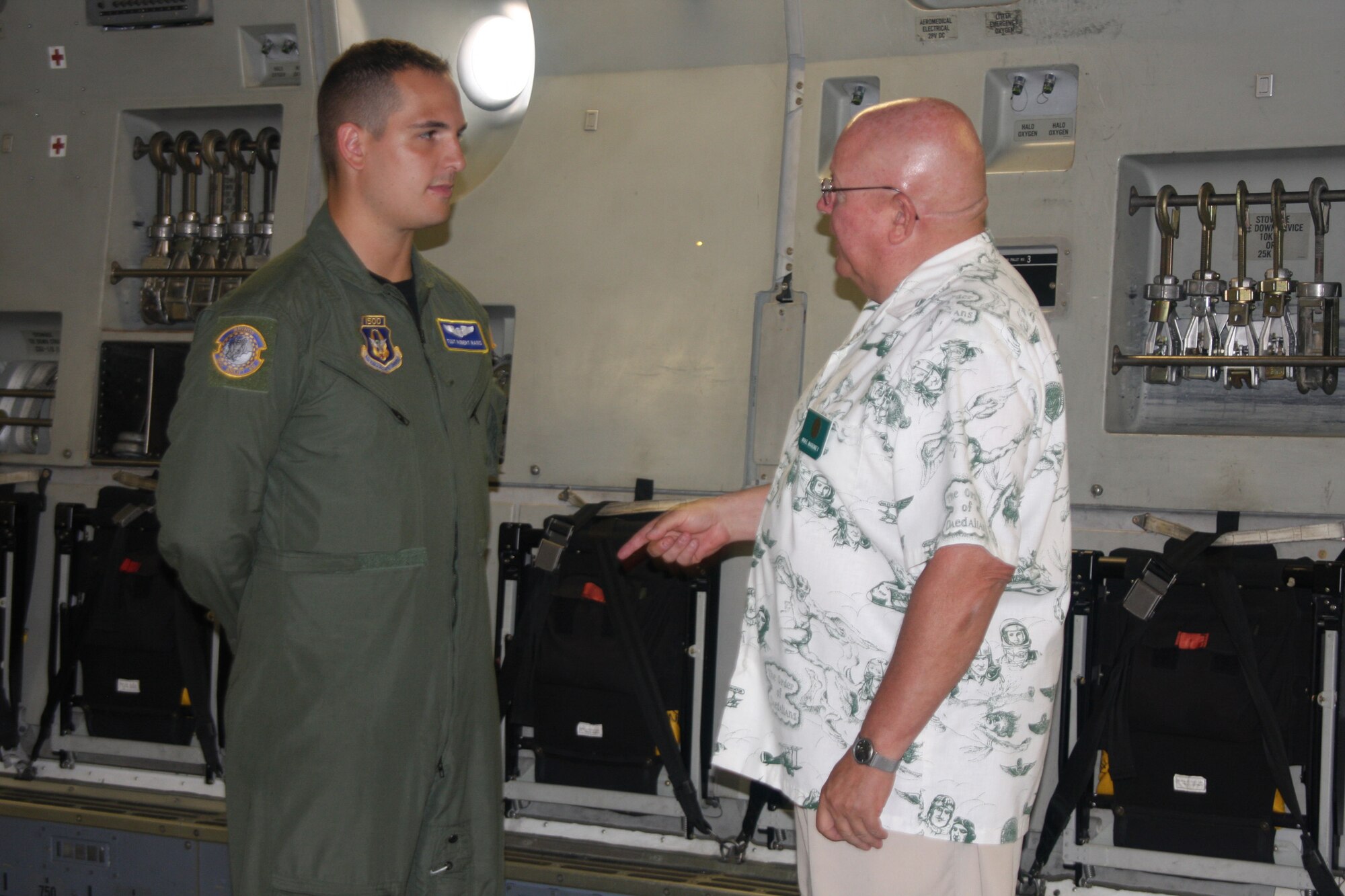 WRIGHT-PATTERSON AIR FORCE BASE, Ohio – Daedalian Mike Maroney enjoys a conversation about the C-17 Globemaster III with Tech. Sgt. Robert Rains, 89th Airlift Squadron loadmaster, while touring the aircraft July 9.  More than 50 Daedalians spent the afternoon at the 445th Airlift Wing where they met with 89 AS crewmembers and toured the C-17. (U.S. Air Force photo/Stacy Vaughn)
