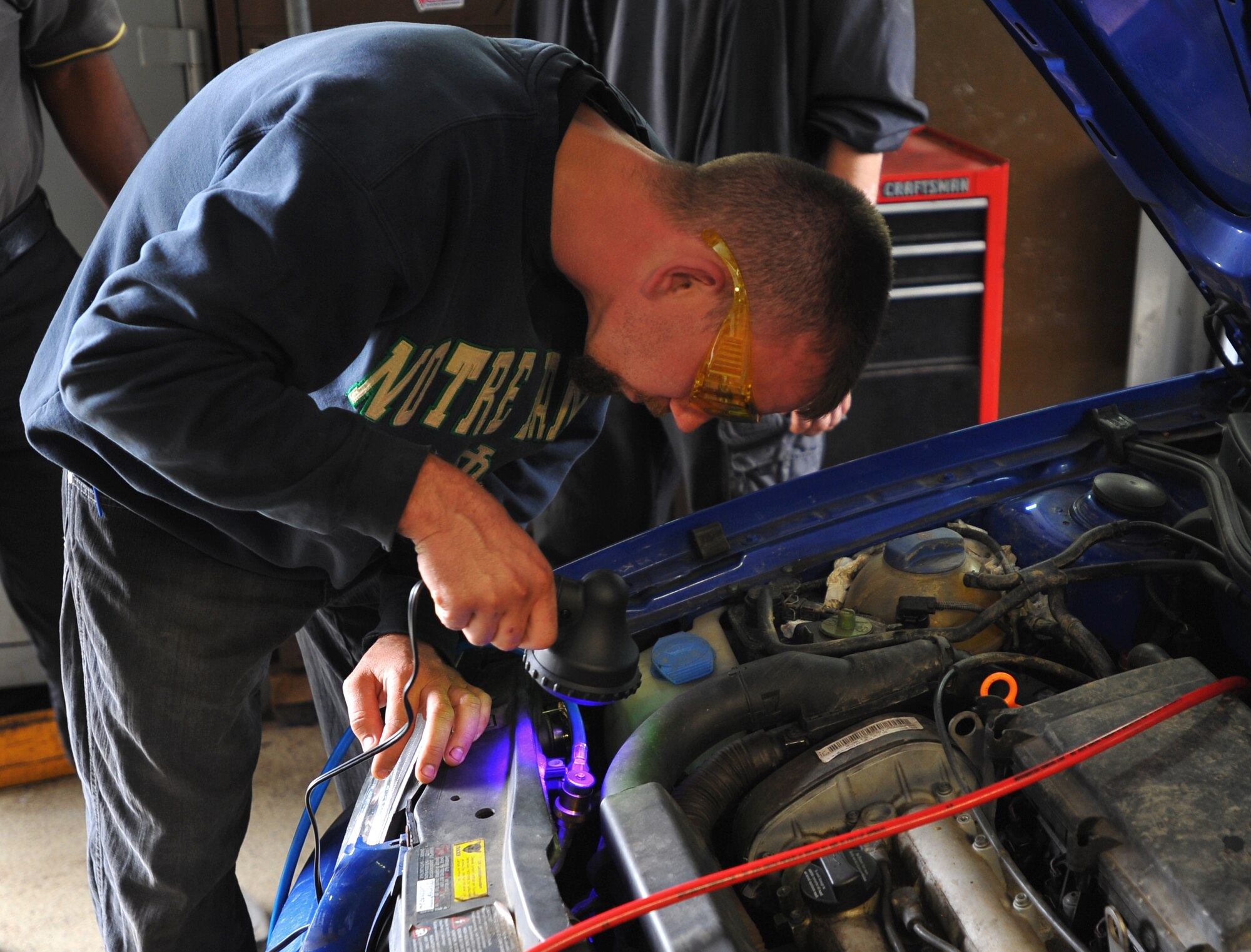 SPANGDAHLEM AIR BASE, Germany – Cory Shaefer, 52nd Force Support Squadron civilian contracted mechanic, uses a black-light to inspect the car’s cooling system for leaks during an automotive class here July 22. The New England Institute of Technology sent an instructor here to teach a five day advanced automotive class for Spangdahlem and Ramstein Air Base FSS automotive mechanics. (U.S Air Force photo/Airman 1st Class Dillon Davis)