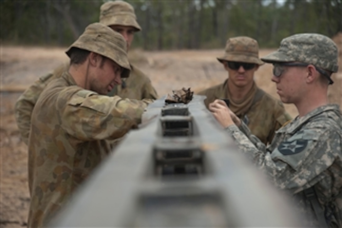 U.S. Army soldiers from the 38th Engineer Company, 4th Stryker Brigade, 2nd Infantry Division and sappers from Australia's 2nd Troop, 1st Field Squadron, 1st Combat Engineer Regiment, plant plastic explosives to cut through a metal obstacle during Talisman Sabre 2011 at Shoalwater Bay Military Training Area in the Australian state of Queensland on July 15, 2011.  Talisman Sabre is a combined biennial exercise between the U.S. and Australian militaries designed to enhance both nationsí ability to respond to regional contingencies.  