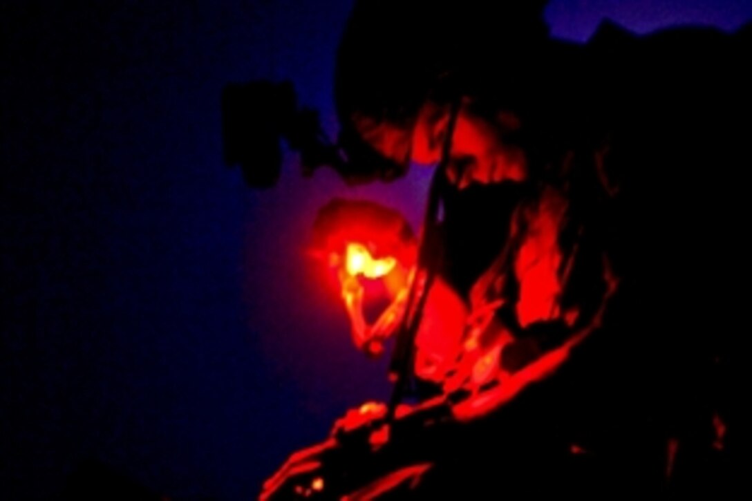 A U.S. Army soldier uses a graphic reference to determine the location of friendly elements while conducting a clearing operation in the Wardak province, Afghanistan, July 18, 2011. The soldier is assigned to Special Operations Task Force East.