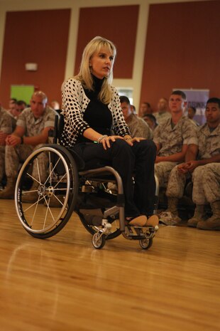 Kelly Narowski, a paraplegic due to a debilitating vehicle wreck, speaks to Marines and sailors about her experiences as well as those of others in the Tinian Room of Marston Pavilion aboard Marine Corps Base Camp Lejeune, July 27. Narowski stressed the importance of making smart decisions in the vehicle and not to let the split-second decisions that can drastically alter one’s life be made hastily.