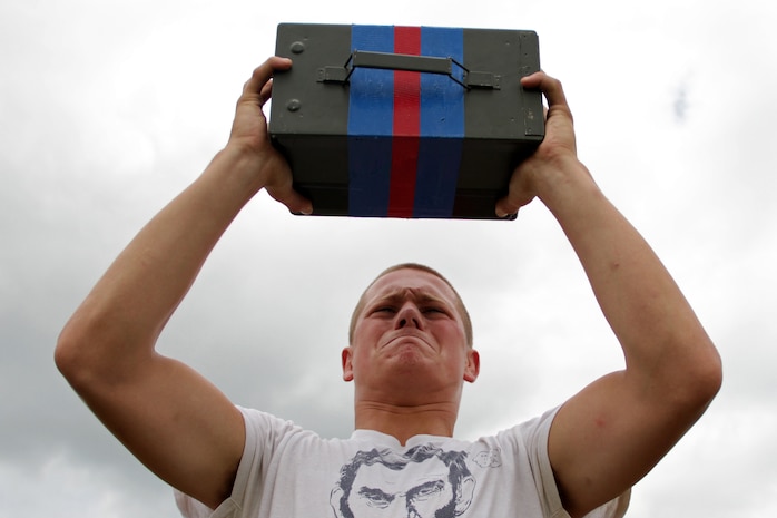 Kyle Crain, from Hudson, Wis., knocks out one more ammo can lift during a strength and cardio training session at the All-Marine Wrestling Camp July 27. Crain, who graduated from Hudson High School, was the 2010 152-pound Wisconsin State Champion and a 2009 Junior National All-American in Greco-Roman. For additional imagery from the event, visit www.facebook.com/rstwincities.  ::r::::n::wiaa