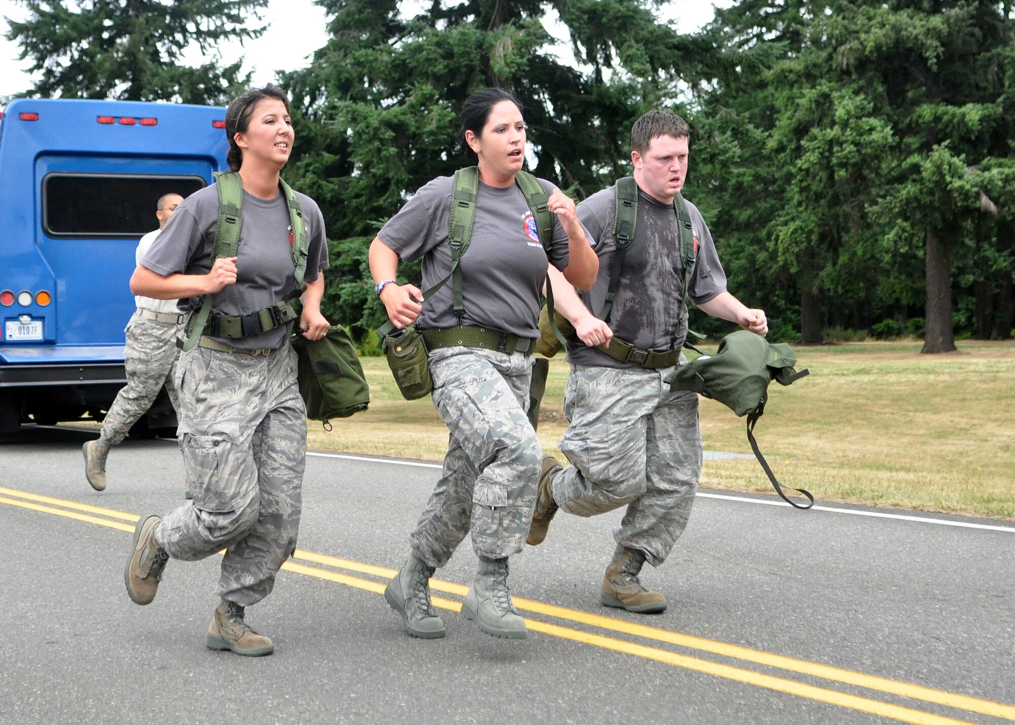 The 62nd Financial Management Rodeo team finishes the two-mile run during the challenge course as part of the Air Mobility Rodeo competition July 26, 2011, at Joint Base Lewis-McChord, Wash. Sit-ups, push-ups and a two-mile run were just a few of the skills tested during the course. Teams were also graded on small arms assembly and Airman’s Manual knowledge. Rodeo is a bi-annual competition that encompasses all aspects of Air Mobility Command, including aerial port, aeromedical evacuation, maintenance, security forces, and financial management. (U.S. Air Force photo/Airman 1st Class Leah Young) 