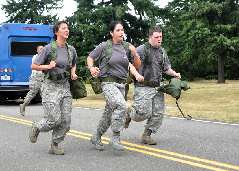 The 62nd Airlift Wing's financial management Rodeo team finishes the two-mile run during the challenge course as part of the Air Mobility Rodeo competition July 26, 2011, at Joint Base Lewis-McChord, Wash. Sit-ups, push-ups and a two-mile run were just a few of the skills tested during the course. Teams were also graded on small arms assembly and Airman’s Manual knowledge. Rodeo is a bi-annual competition that encompasses all aspects of Air Mobility Command, including aerial port, aeromedical evacuation, maintenance, security forces, and financial management. (U.S. Air Force Photo/Airman 1st Class Leah Young)