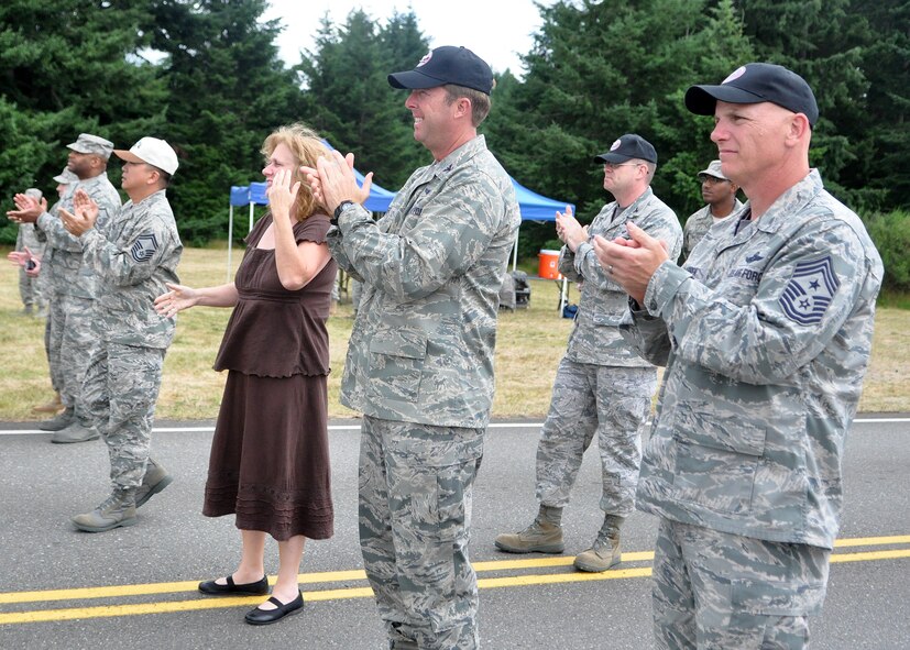 62nd Airlift Wing leadership cheers on the three-person Financial Management Rodeo team as they complete the challenge course July 26, 2011, at Joint Base Lewis-McChord, Wash. Rodeo is a bi-annual competition that encompasses all aspects of Air Mobility Command, including aerial port, aeromedical evacuation, maintenance, security forces, and financial management. (U.S. Air Force Photo/Airman 1st Class Leah Young)