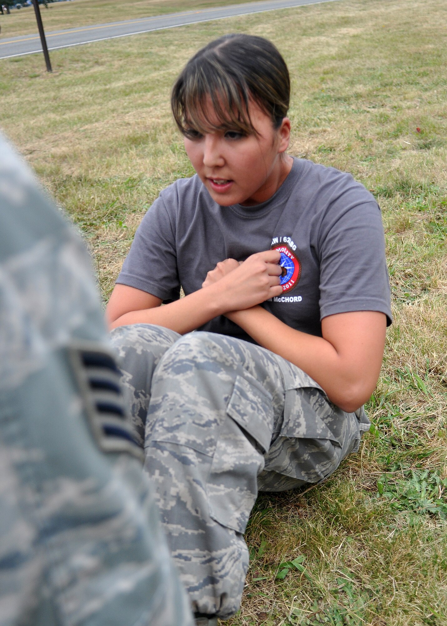 Staff Sgt. Juliana Perry, 62nd Financial Management team member, does sit-ups during a challenge course as part of Air Mobility Rodeo July 26, 2011, at Joint Base Lewis-McChord, Wash. Sit-ups, push-ups and a two-mile run were just a few of the skills tested during the course. Teams were also graded on small arms assembly and Airman’s Manual knowledge. Rodeo is a bi-annual competition that encompasses all aspects of Air Mobility Command, including aerial port, aeromedical evacuation, maintenance, security forces, and financial management. (U.S. Air Force photo/Airman 1st Class Leah Young)