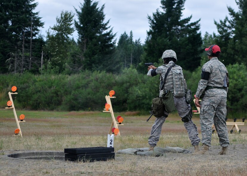 Staff Sgt. Avriel Campbell, 627th Security Forces Squadron Rodeo team member, fires a pistol during a combat weapons course as part of Air Mobility Rodeo on July 26, 2011, at Joint Base Lewis-McChord, Wash. The course also required the four-person team to fire an M-16. Rodeo is a bi-annual competition that encompasses all aspects of Air Mobility Command, including aerial port, aeromedical evacuation, maintenance, security forces, and financial management. (U.S. Air Force Photo/Airman 1st Class Leah Young) 