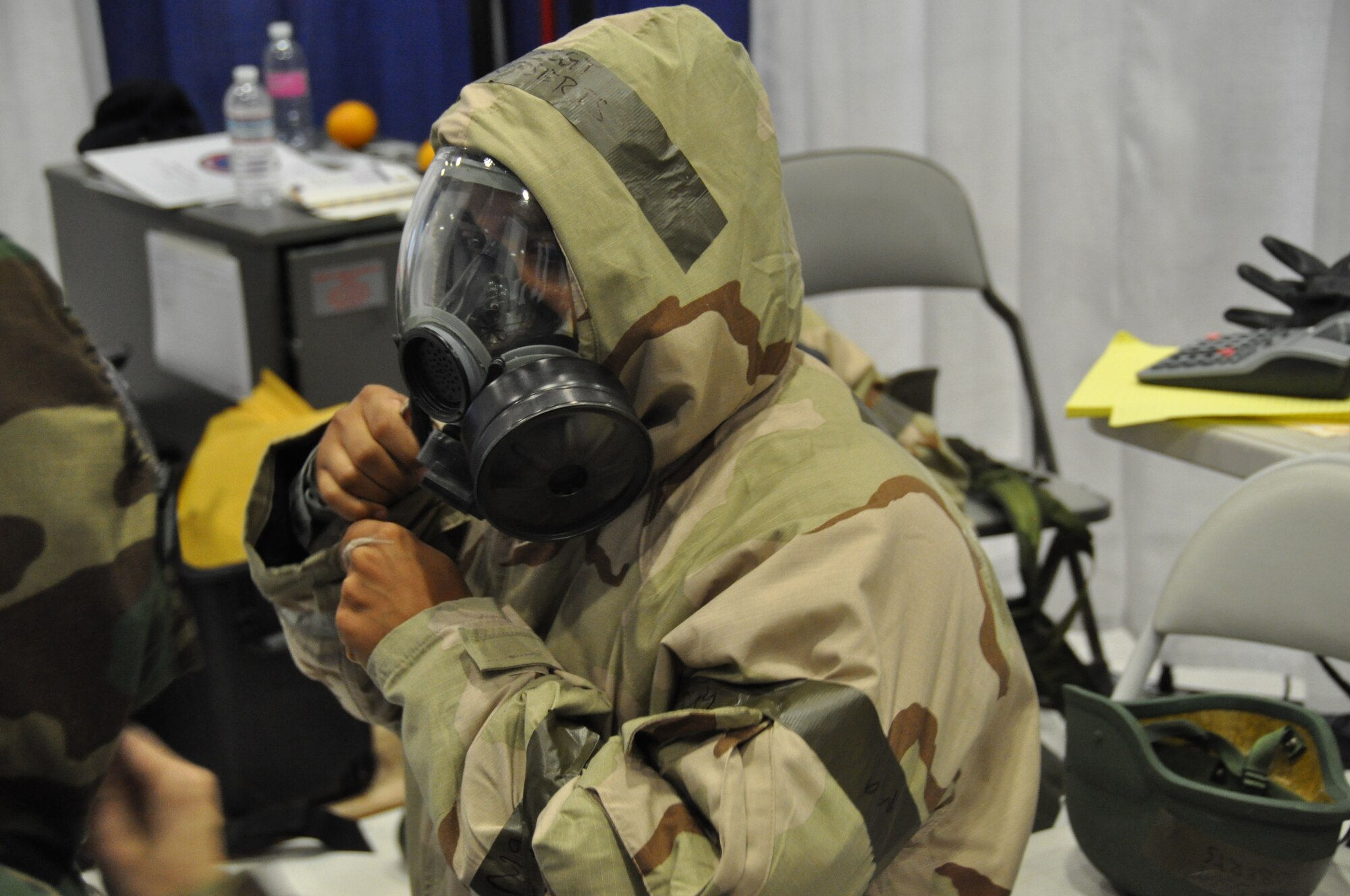 Staff Sgt, Larry Roberts, 60th Comptroller Squadron, suits up in military oriented protective posture gear during an alarm red scenario for the financial management competition July 25, 2011 during the Air Mobility Rodeo 2011. U.S. Air Force photo/Airman 1st Class Michael Battles)