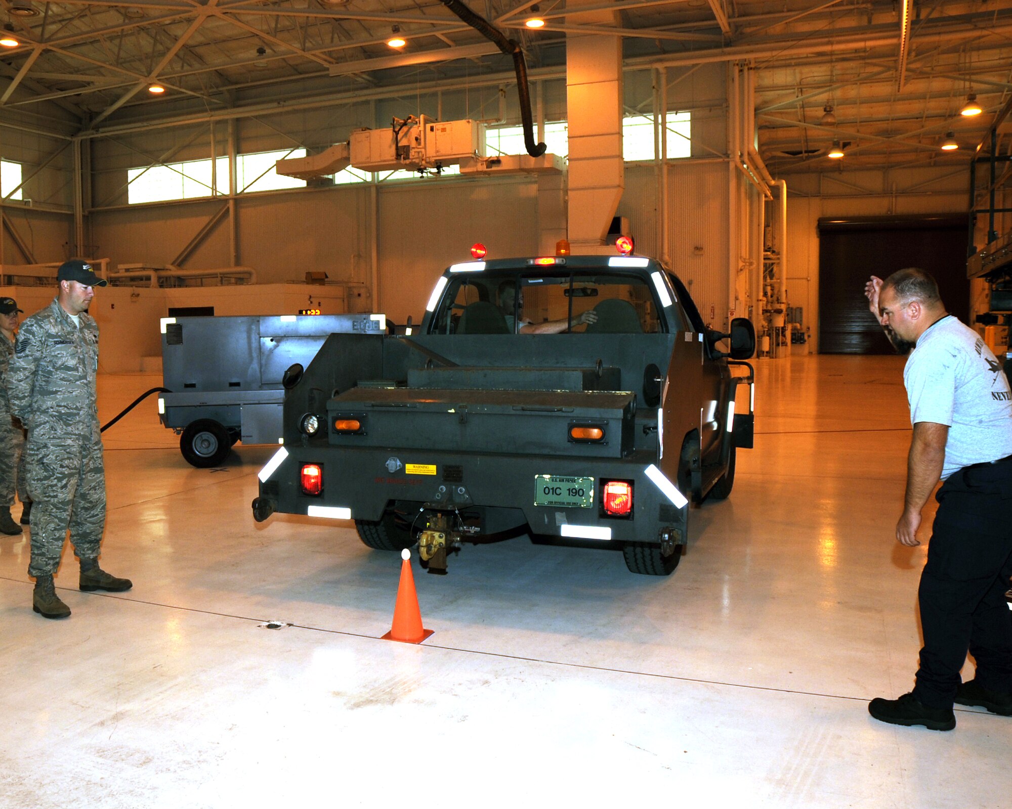 JOINT BASE LEWIS-MCCHORD, Wash. – A 2011 Air Mobility Command Rodeo umpire watches Joshua Fraser, 97th Maintenance Directorate KC-135 Rodeo Team member, back up a Bobtail as teammate Brian King directs him within inches of an egg during the Maintenance Skills Course July 27, 2011. The MSC tests maintenance teams on their ability to complete day-to-day tasks while under a time constraint.   (U.S. Air Force photo by Airman 1st Class Kenneth W. Norman / Released / 97th Air Mobility Wing Rodeo Public Affairs)