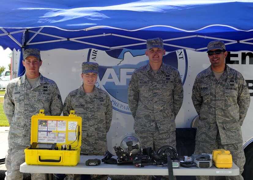 Members from the 319th Civil Engineer Squadron work a hazardous response equipment display booth July 26 on Grand Forks Air Force Base, N.D.  The bases Army and Air Force Exchange Service provided multiple display booths to recognize 116 years of service and support to America's military. (U.S. Air Force photo by Senior Airman Amber Bennett)