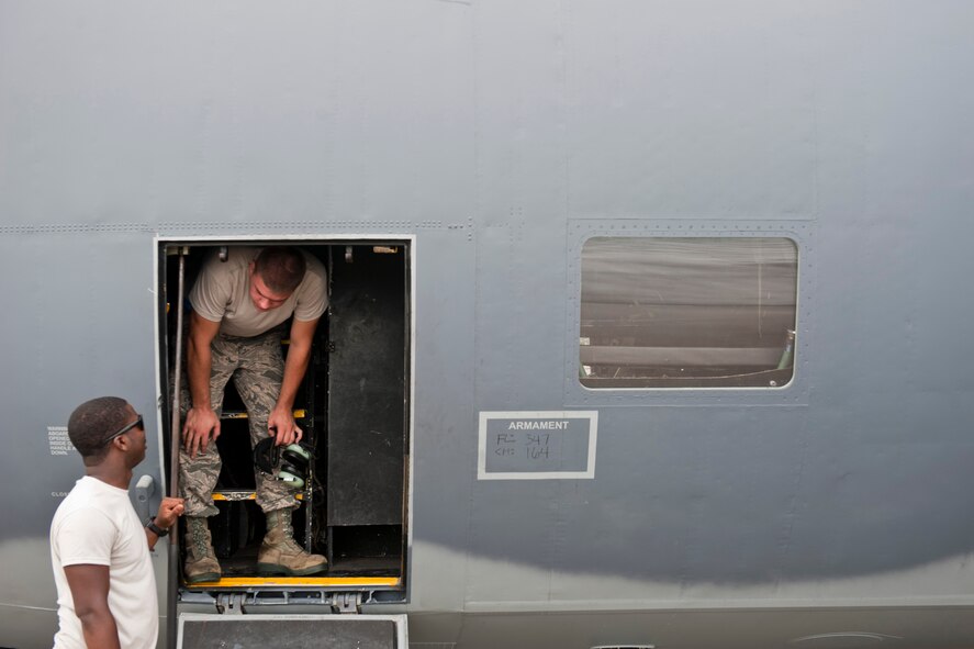 U.S. Air Force Senior Airman Justin Davis and Airman 1st Class Anthony Davis, 723rd Aircraft Maintenance Squadron crew chiefs, discuss maintenance operations while recovering an HC-130P Combat King at Moody Air Force Base, Ga., July 27, 2011. Since the aircraft was scheduled to conduct another mission later that evening, Davis and Davis only had to complete some of the recovery procedures. (U.S. Air Force photo by Staff Sgt. Jamal D. Sutter/Released)